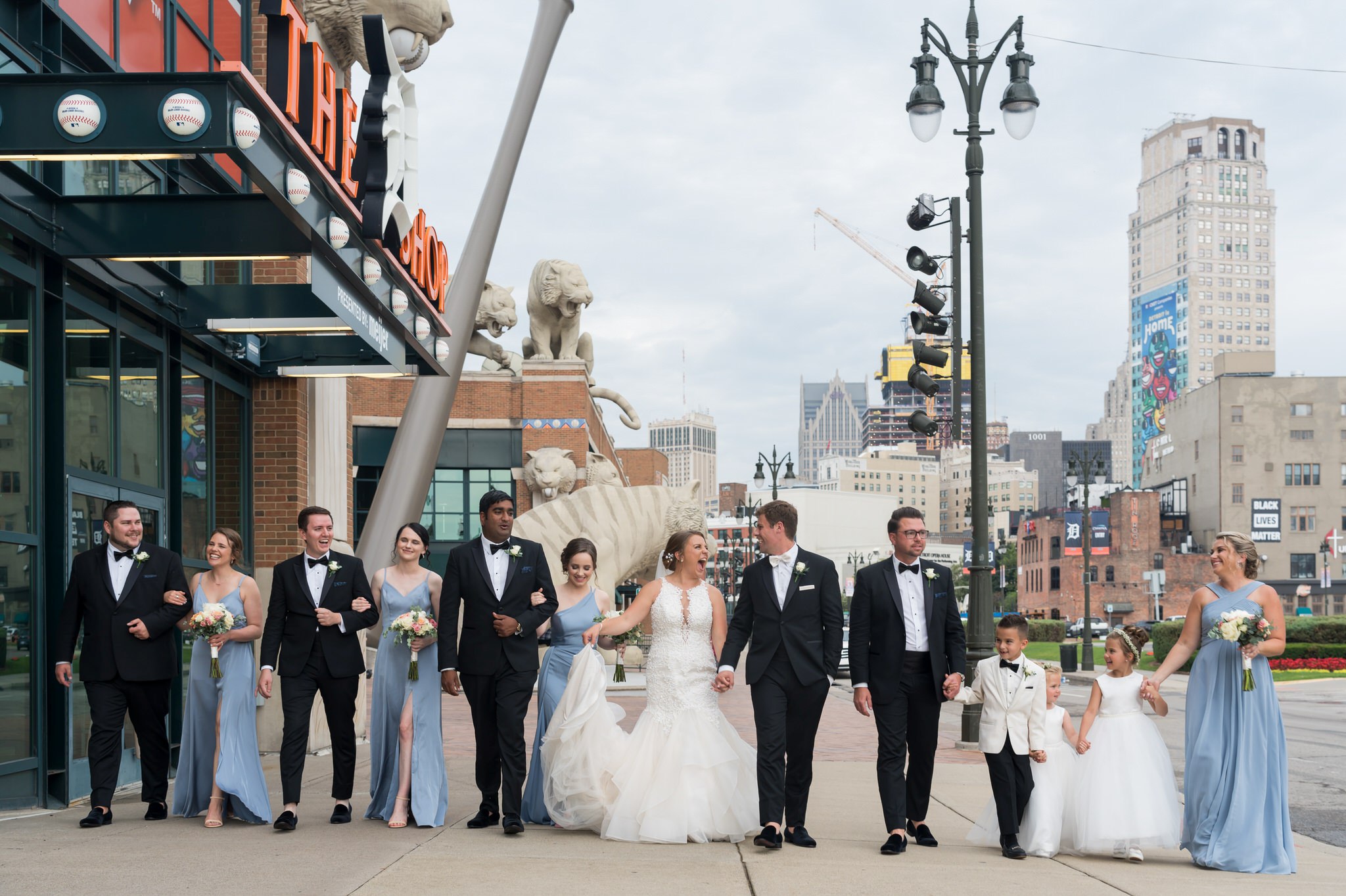 A bridal party walks in front of Comerica Park.  