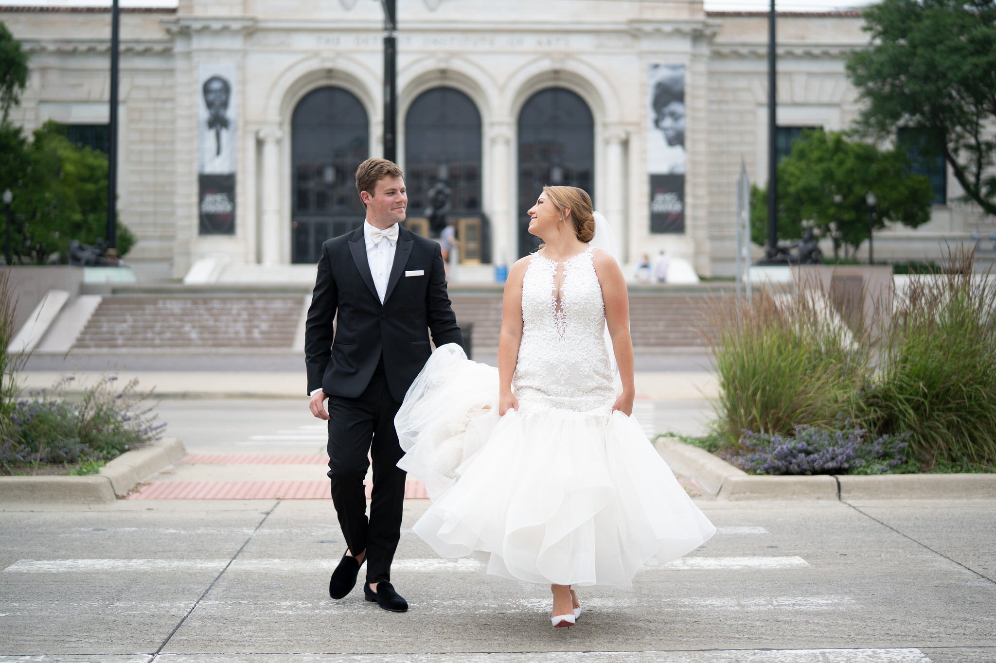 A bride and groom cross Woodward Ave on their wedding day.  