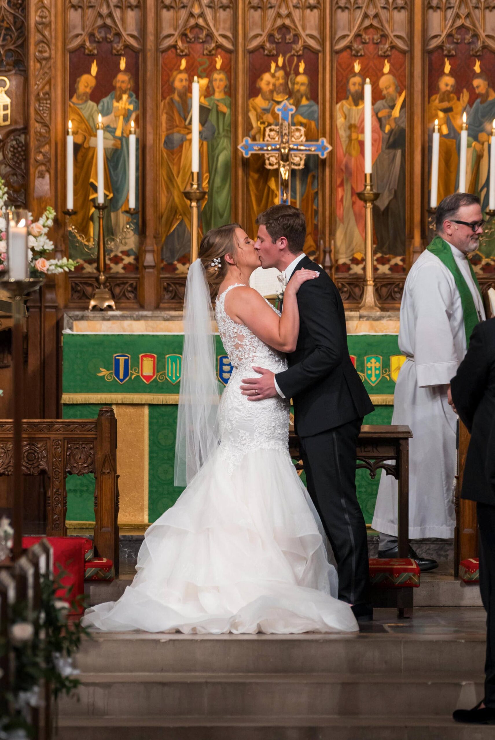 A bride and groom kiss at the altar of Historic Trinity Lutheran Church in Detroit, Michigan.  