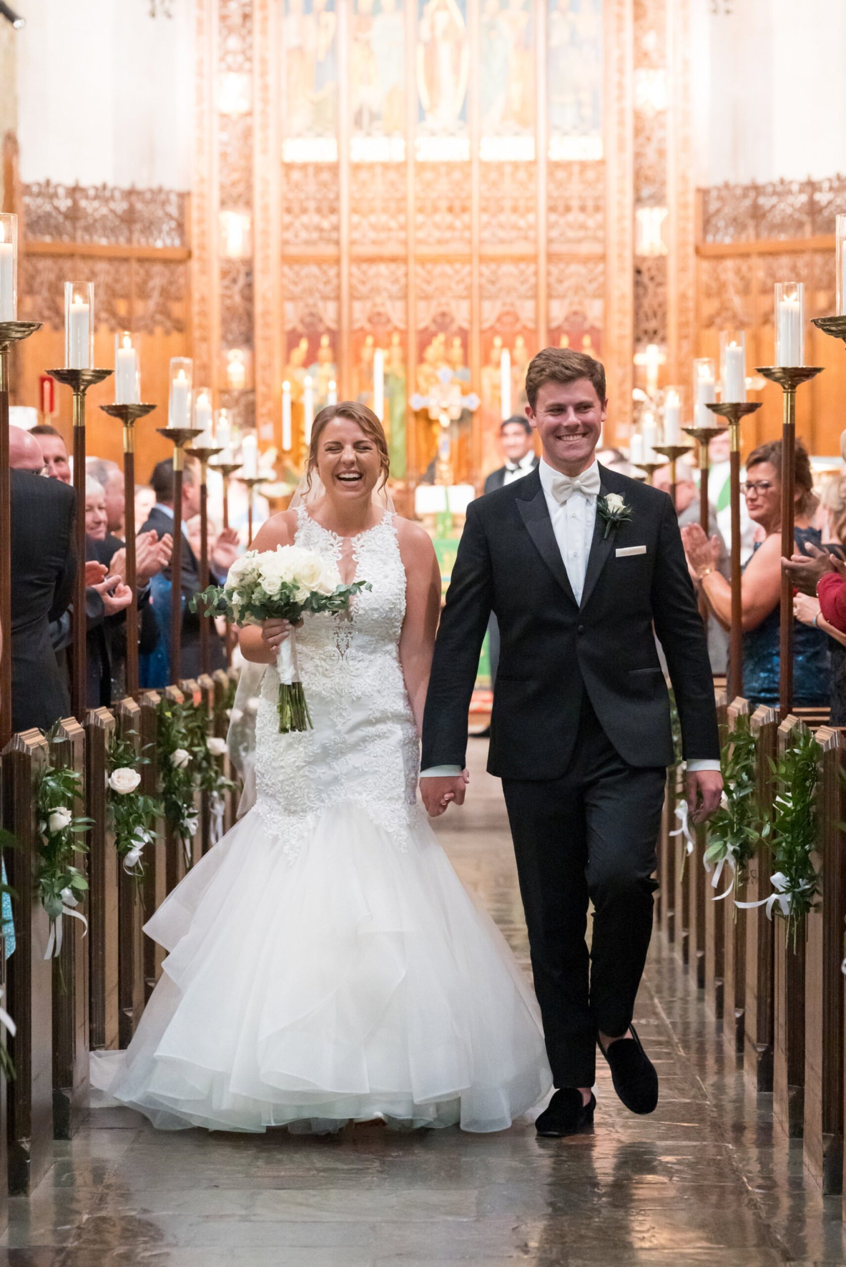A bride and groom walk down the aisle of Historic Trinity Lutheran Church in Detroit, Michigan.  
