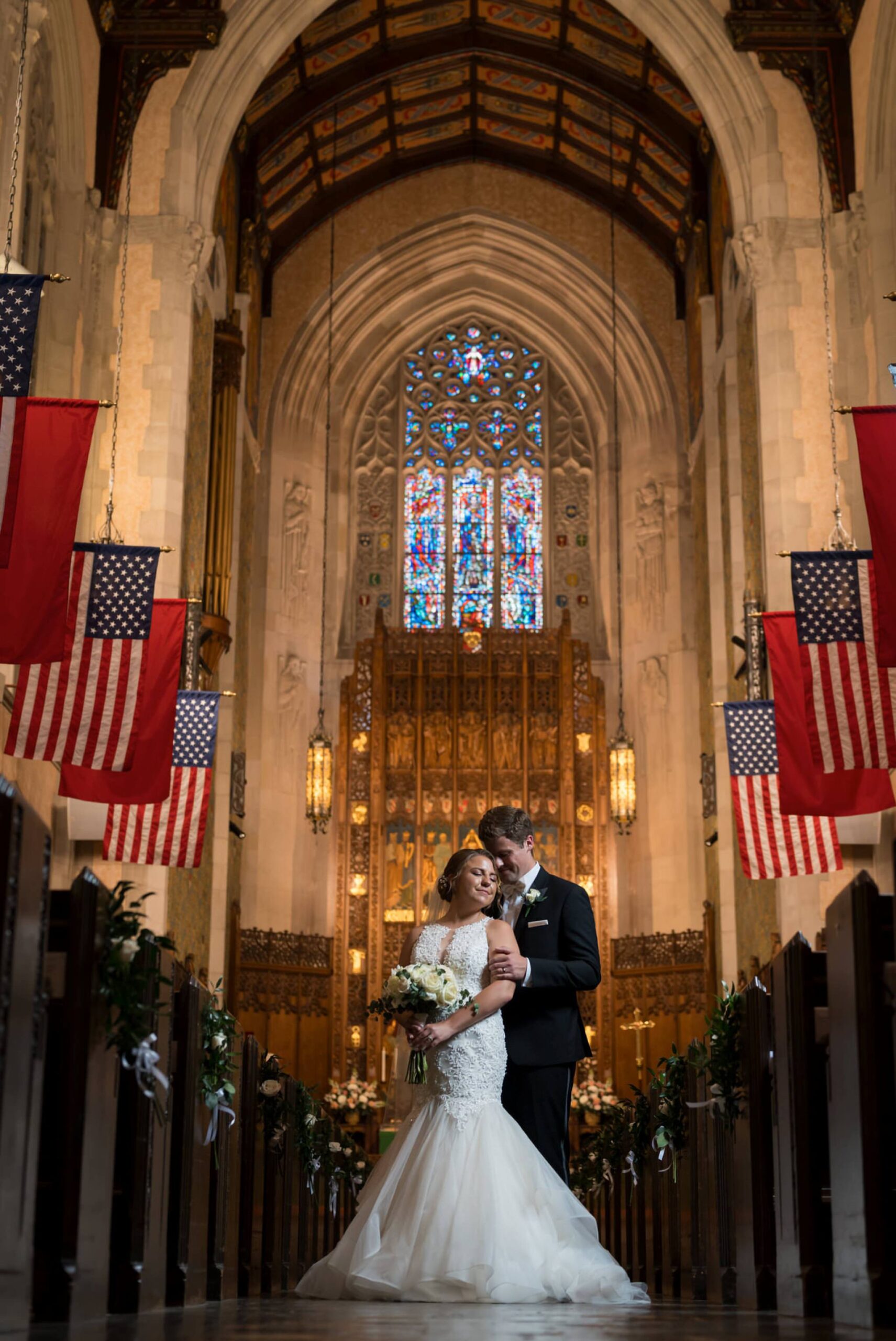 A bride and groom embrace in the aisle of Historic Trinity Lutheran Church.  