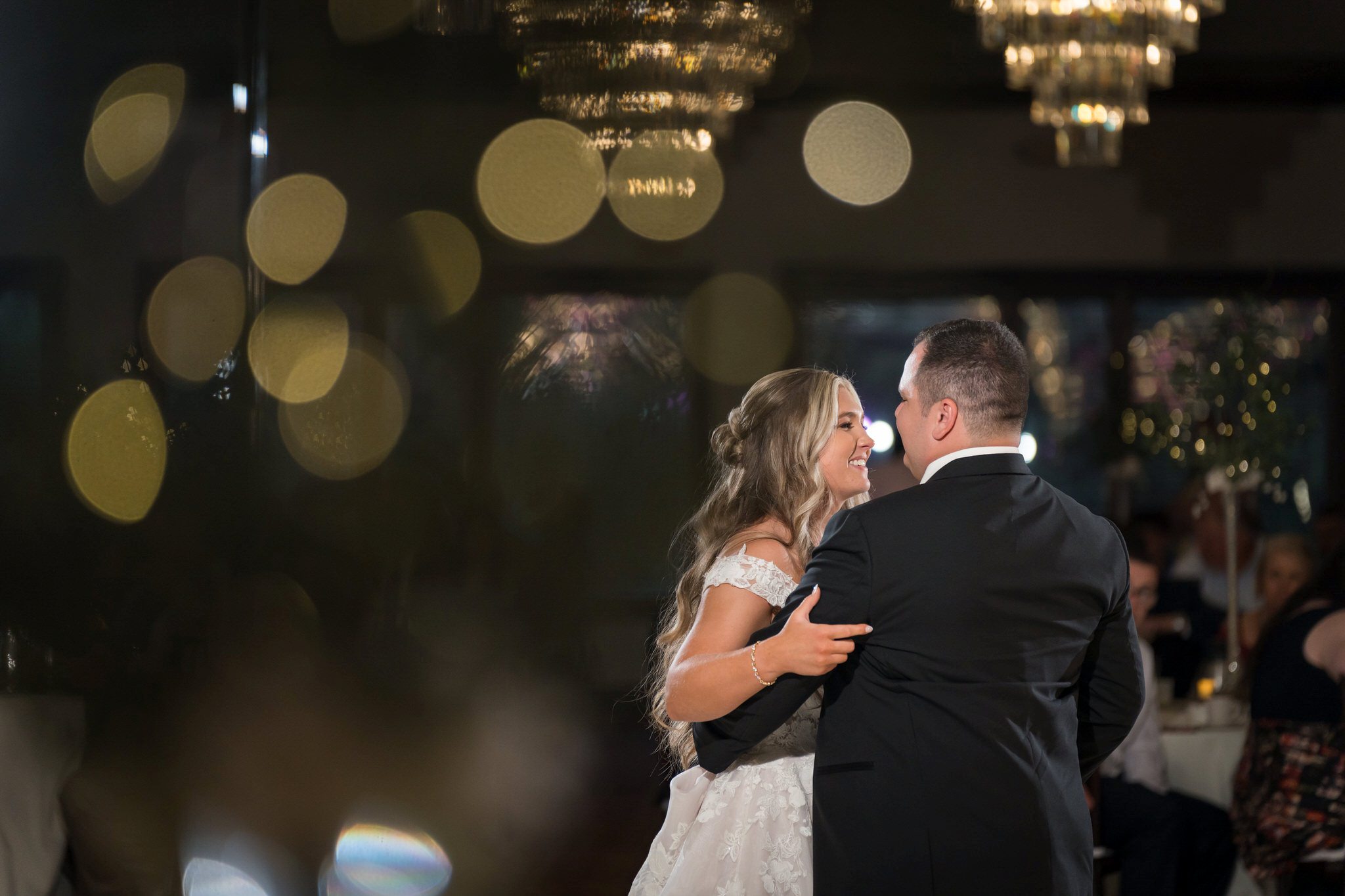 The bride and groom share a first dance at a wedding reception at the Italian American Cultural Society. 