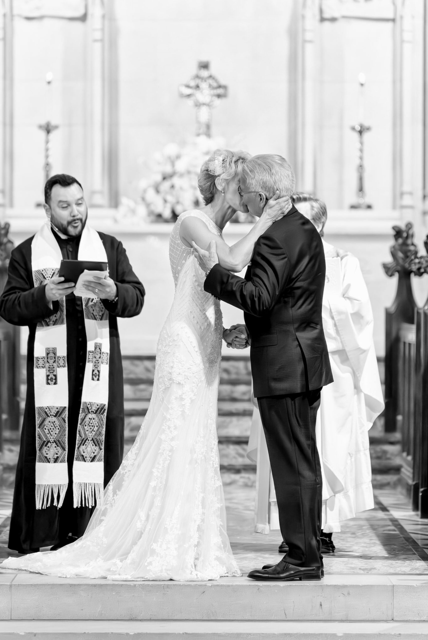 A bride and groom share a first kiss at their Kirk in the Hills wedding.