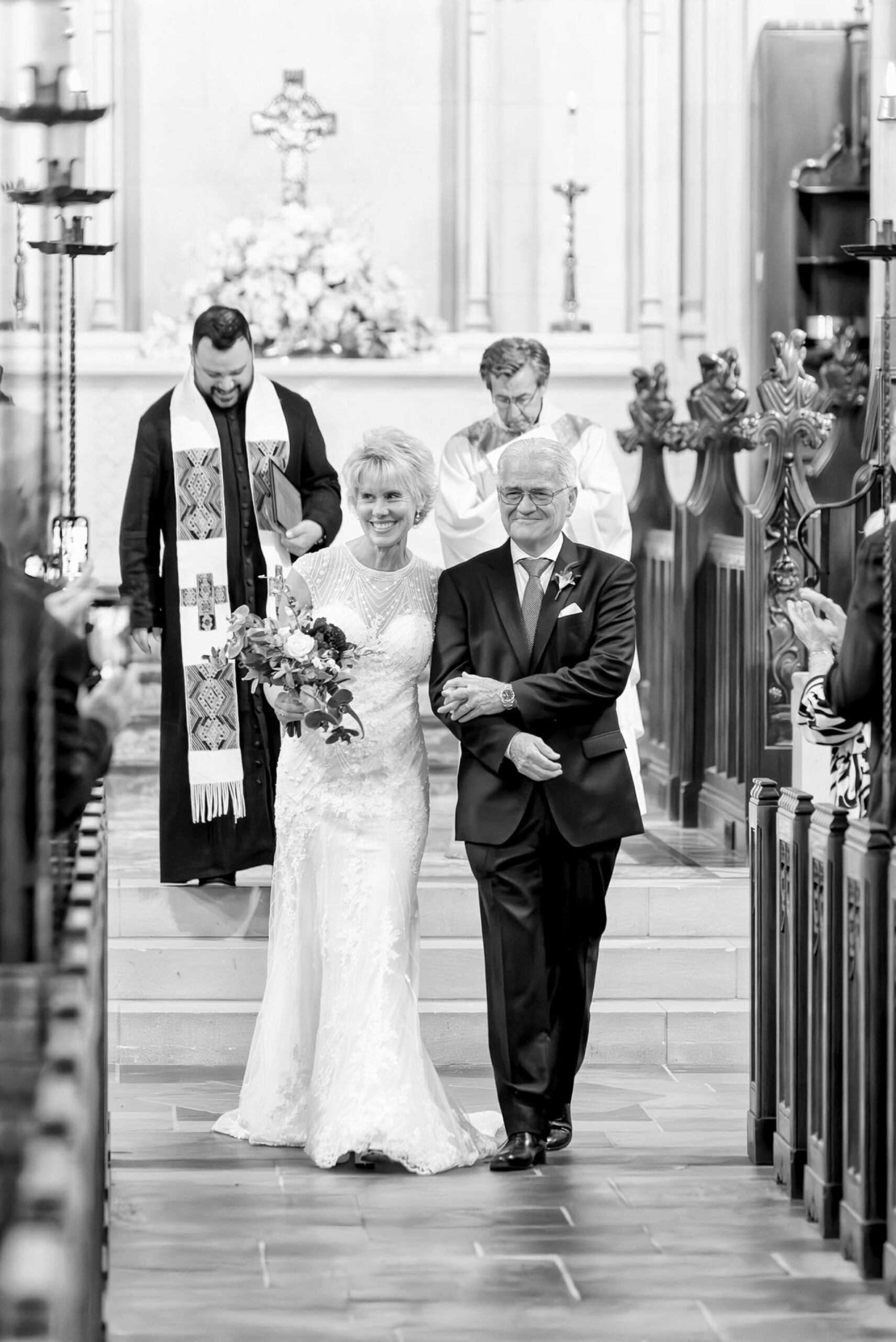 A bride and groom walk down the aisle at their Kirk in the Hills wedding.