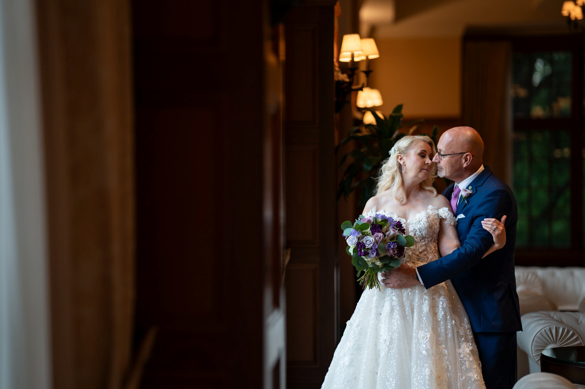 A bride and groom privately embrace in the lobby of their Royal Park wedding. 