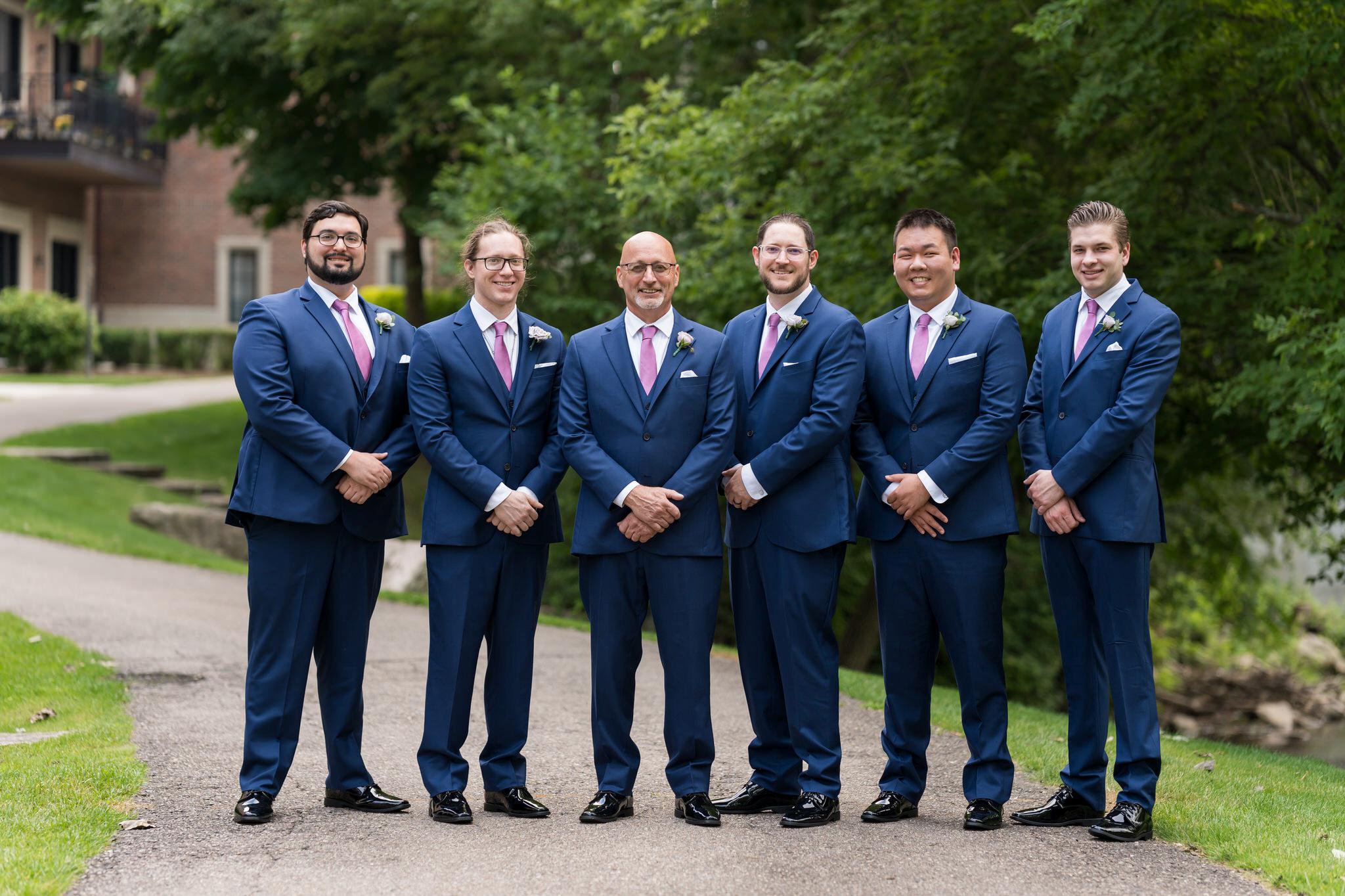 Groomsmen pose outside during a Royal Park wedding. 