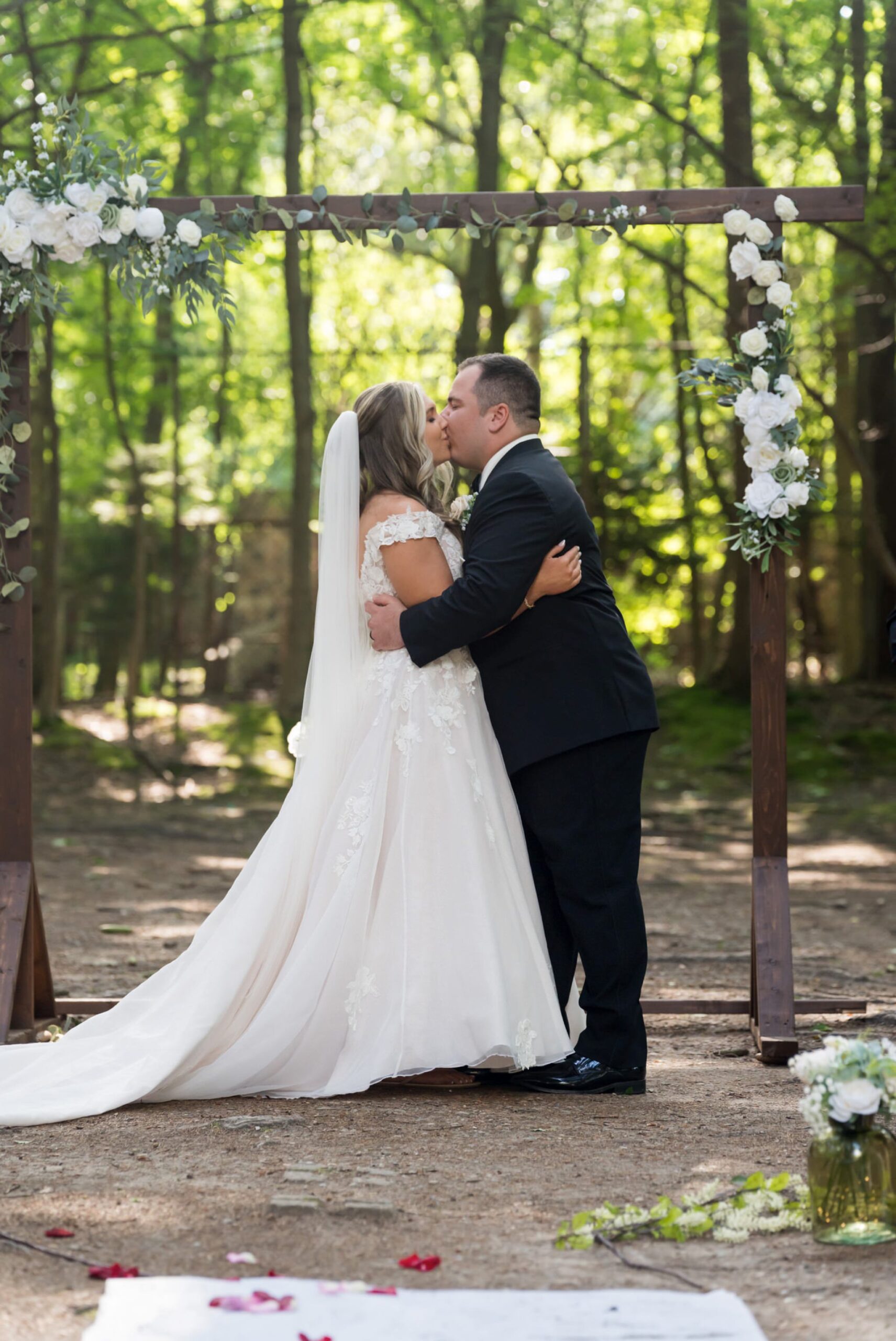 The bride and groom kiss at their Stony Creek wedding in The Pines.  