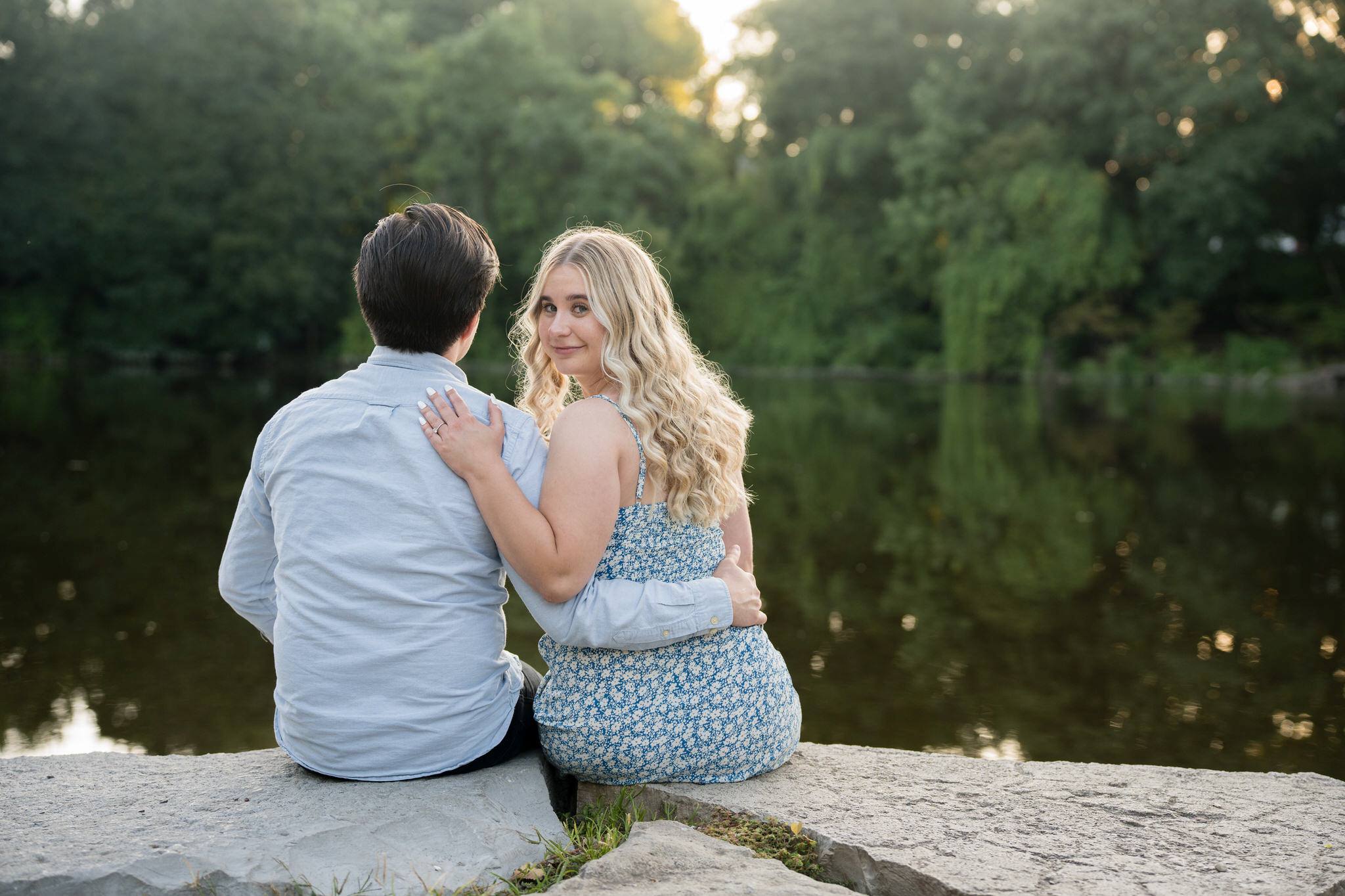 Looking over her shoulder, a fiance looks at the camera after her Quarton Lake proposal. 