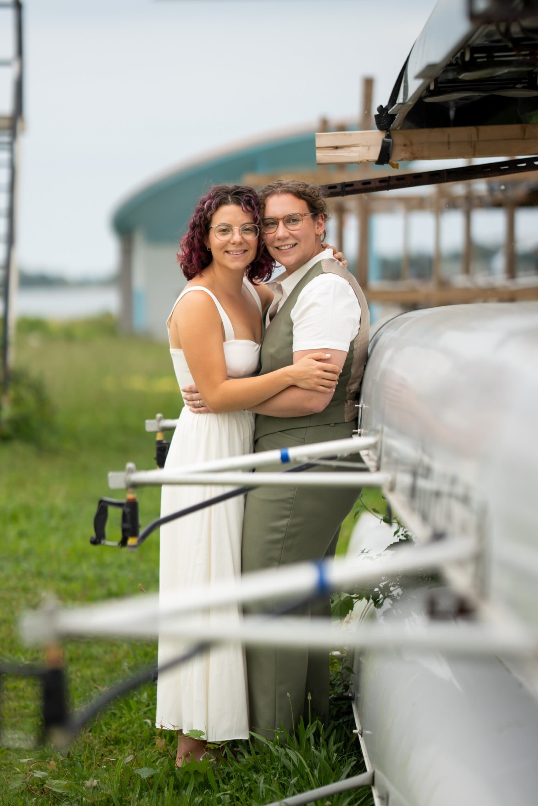 A same sex couple poses at the Belle Isle Boat House on their wedding day. 