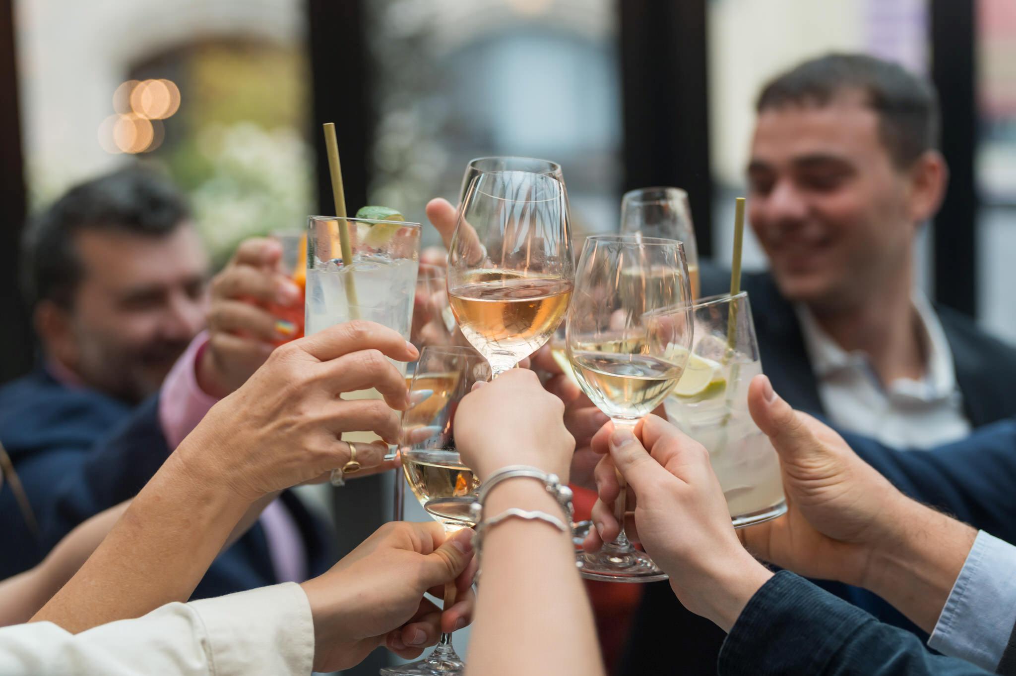 Glasses clink and toast at a wedding at Shinola Hotel