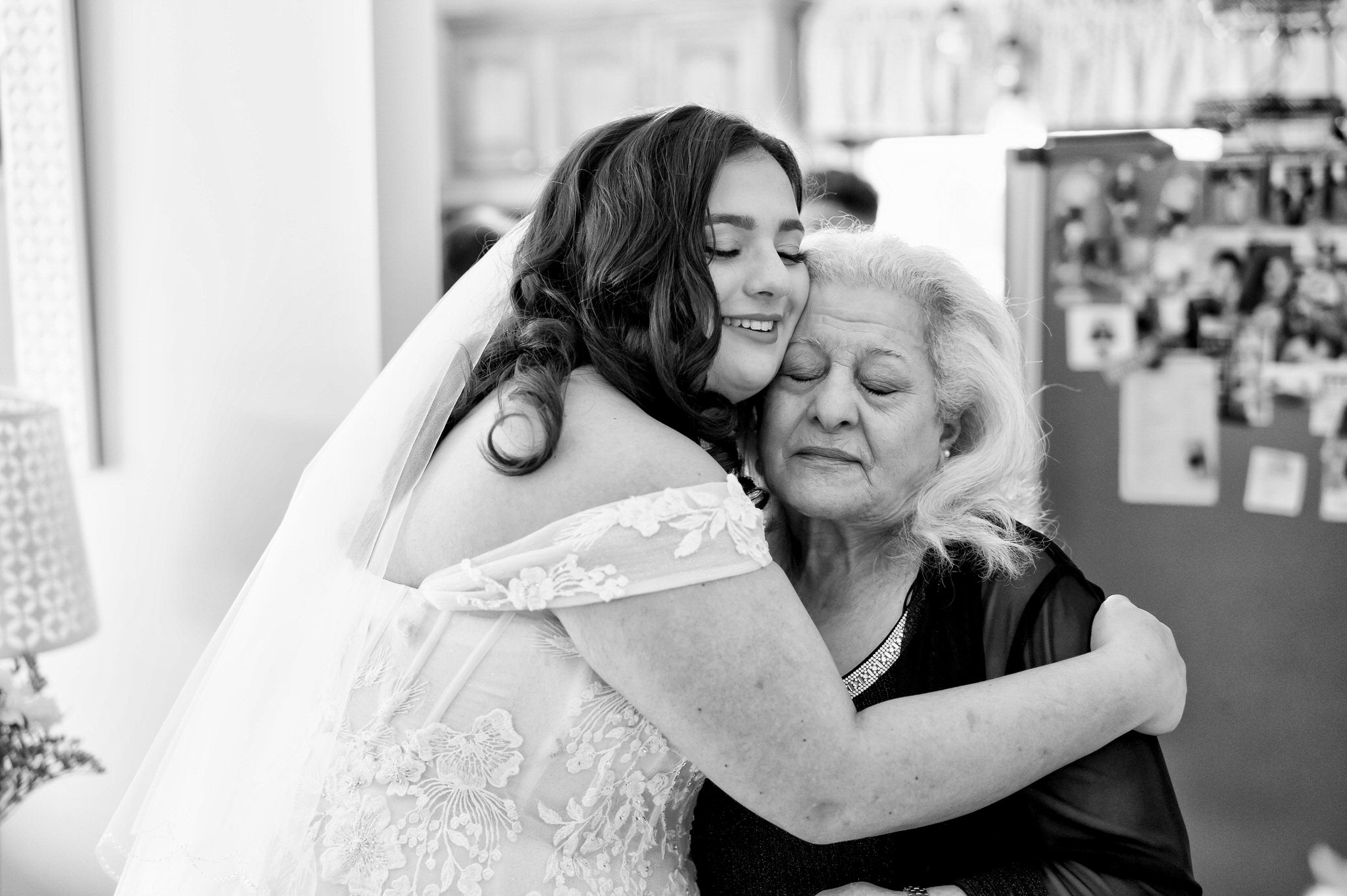 A bride hugs her grandma on her wedding day.  