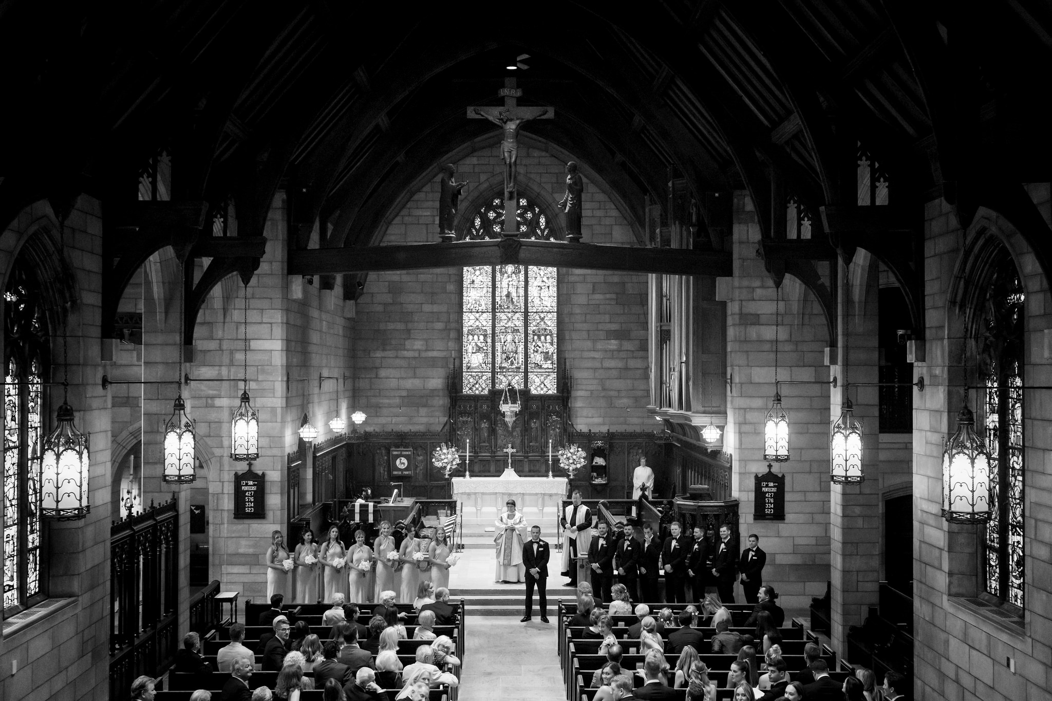 The groom waits at the front of the altar for his bride at Christ Church Grosse Pointe.  