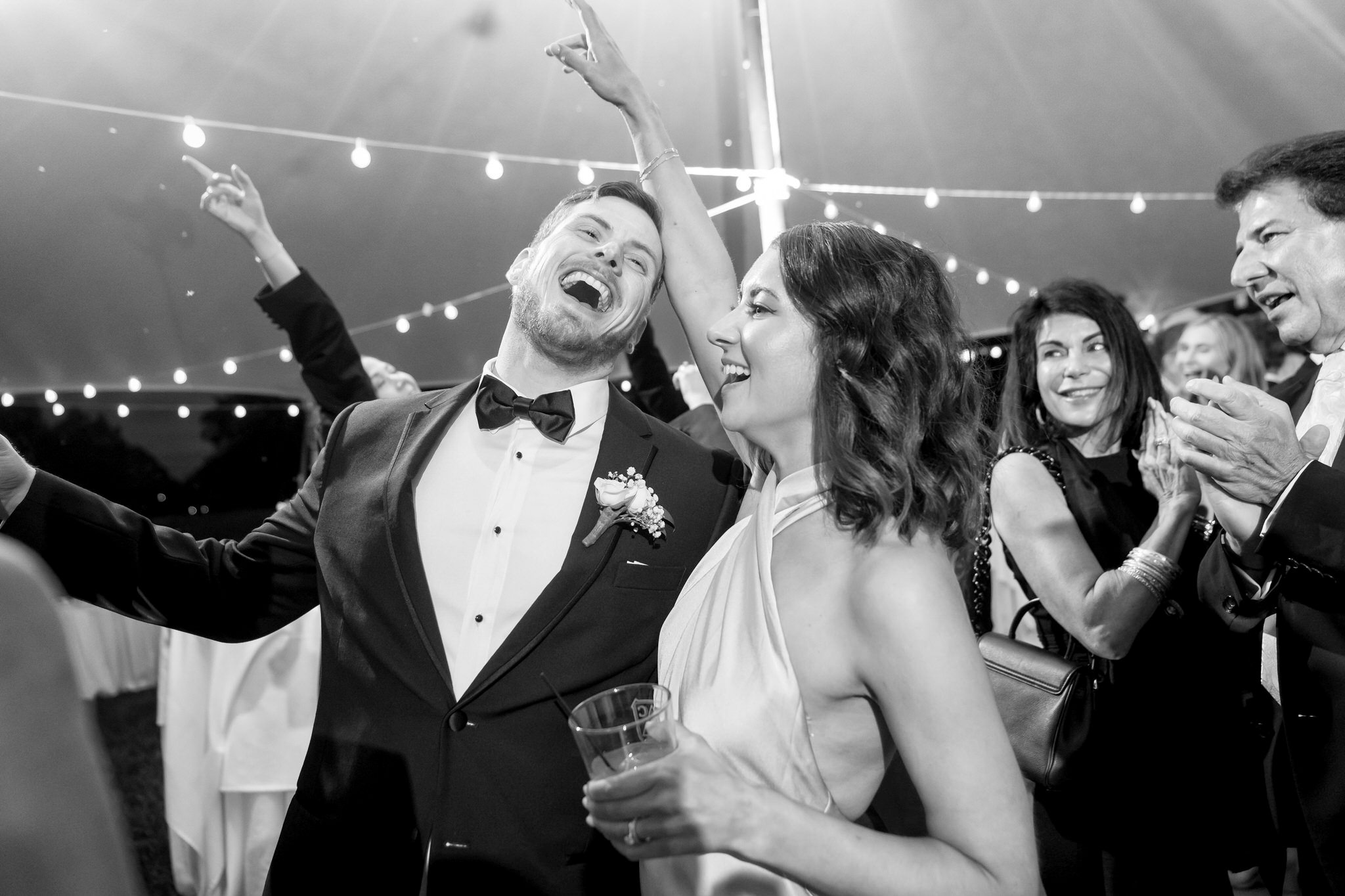 Couple dances under a tent at a Country Club of Detroit wedding. 