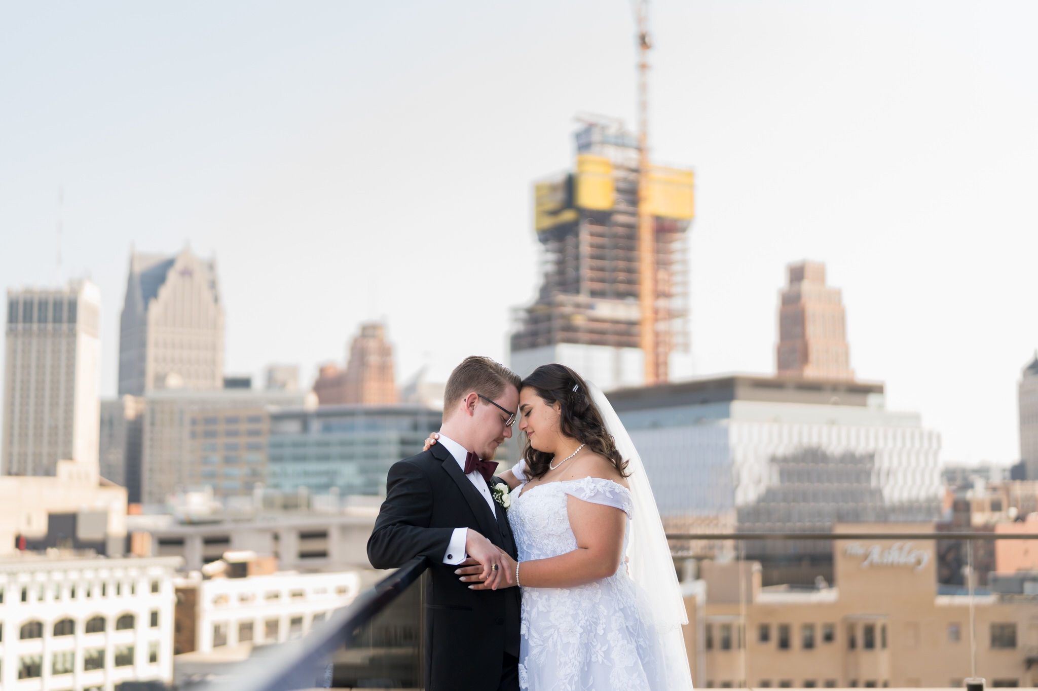 A couple share a quiet moment on top of the rooftop at their Detroit Athletic Club wedding.  
