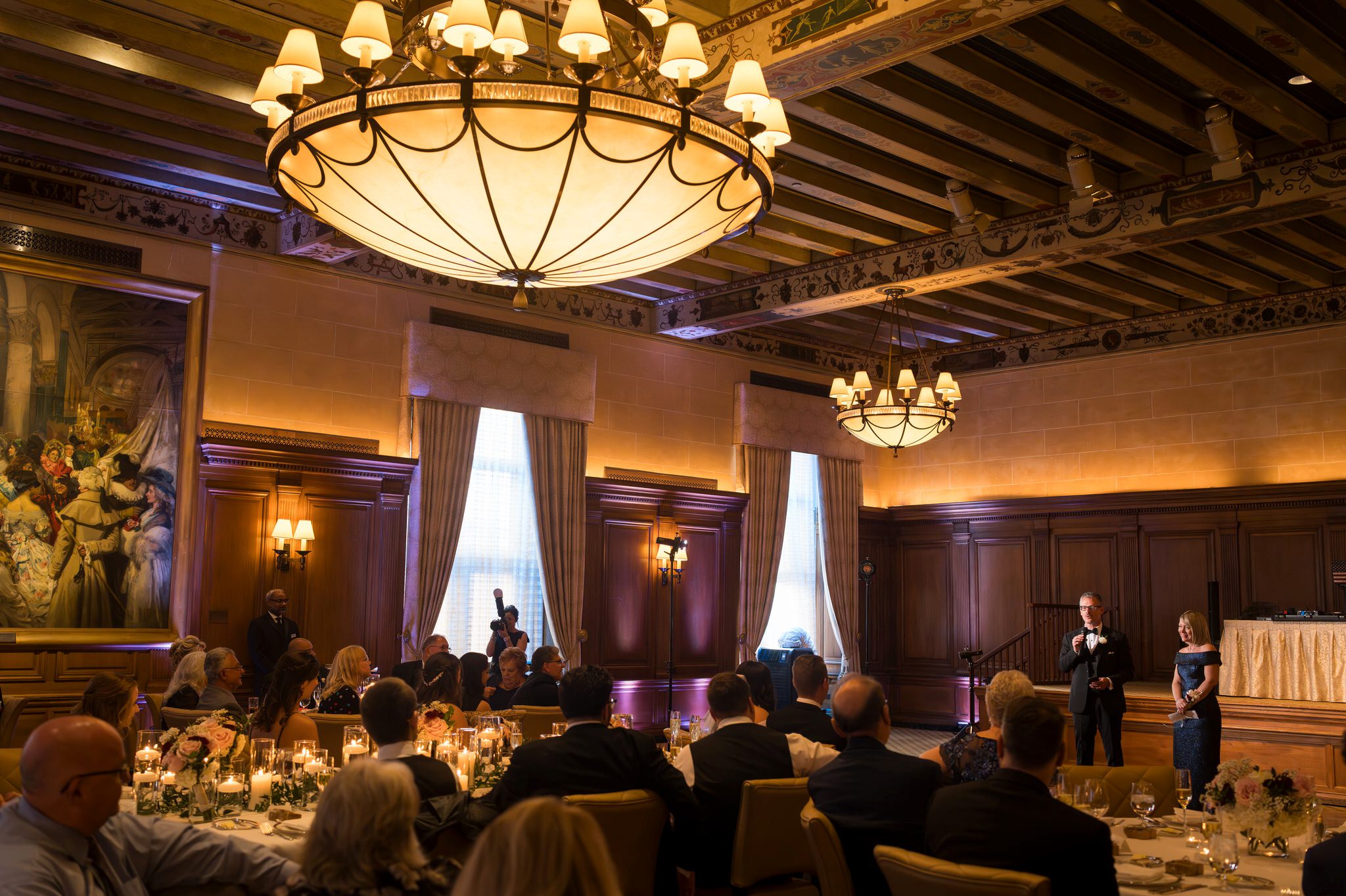 The parents of the groom give a speech at a Detroit Athletic Club wedding.  