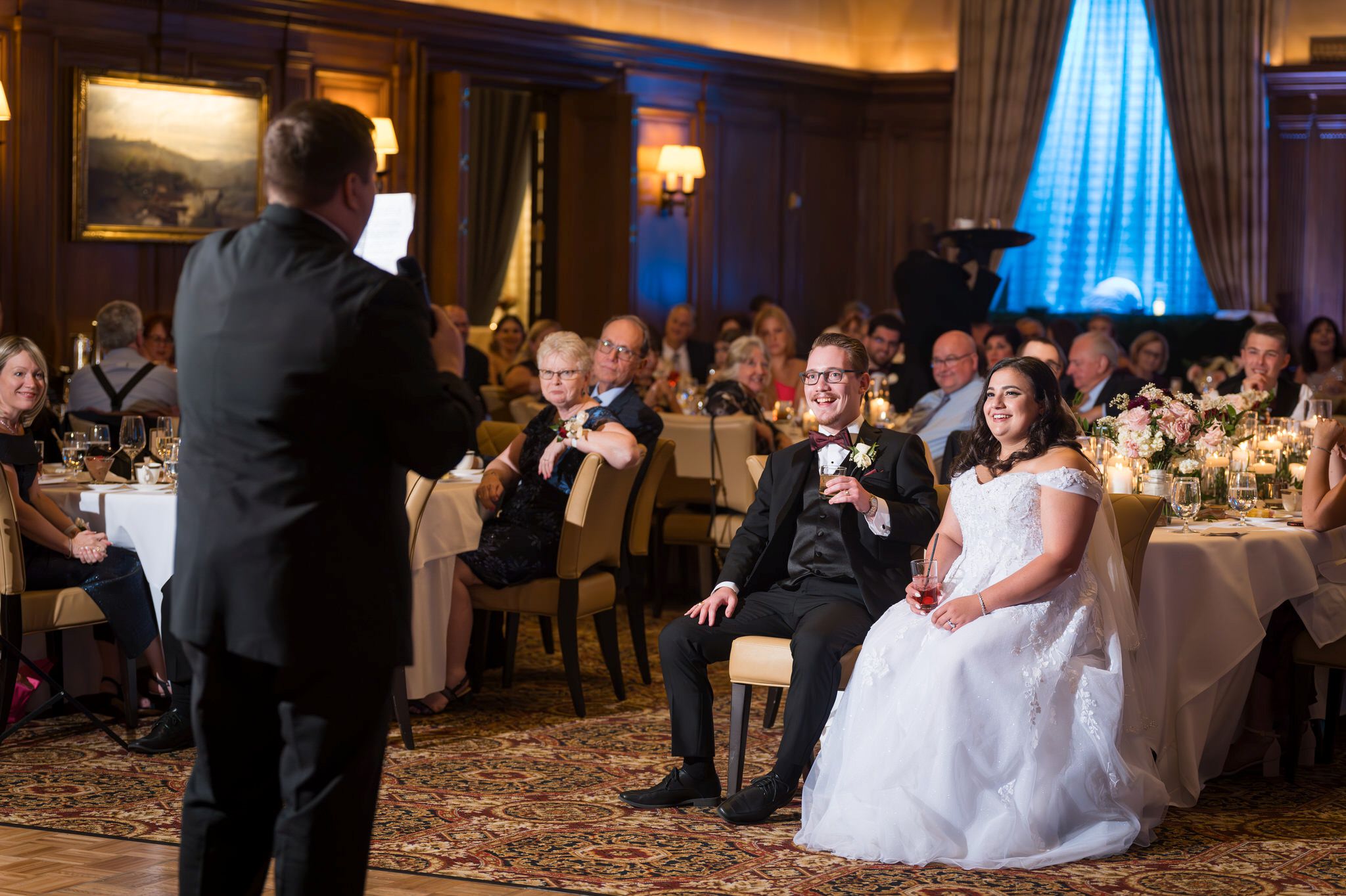 The best man toasts the bride and groom at a Detroit Athletic Club wedding.  