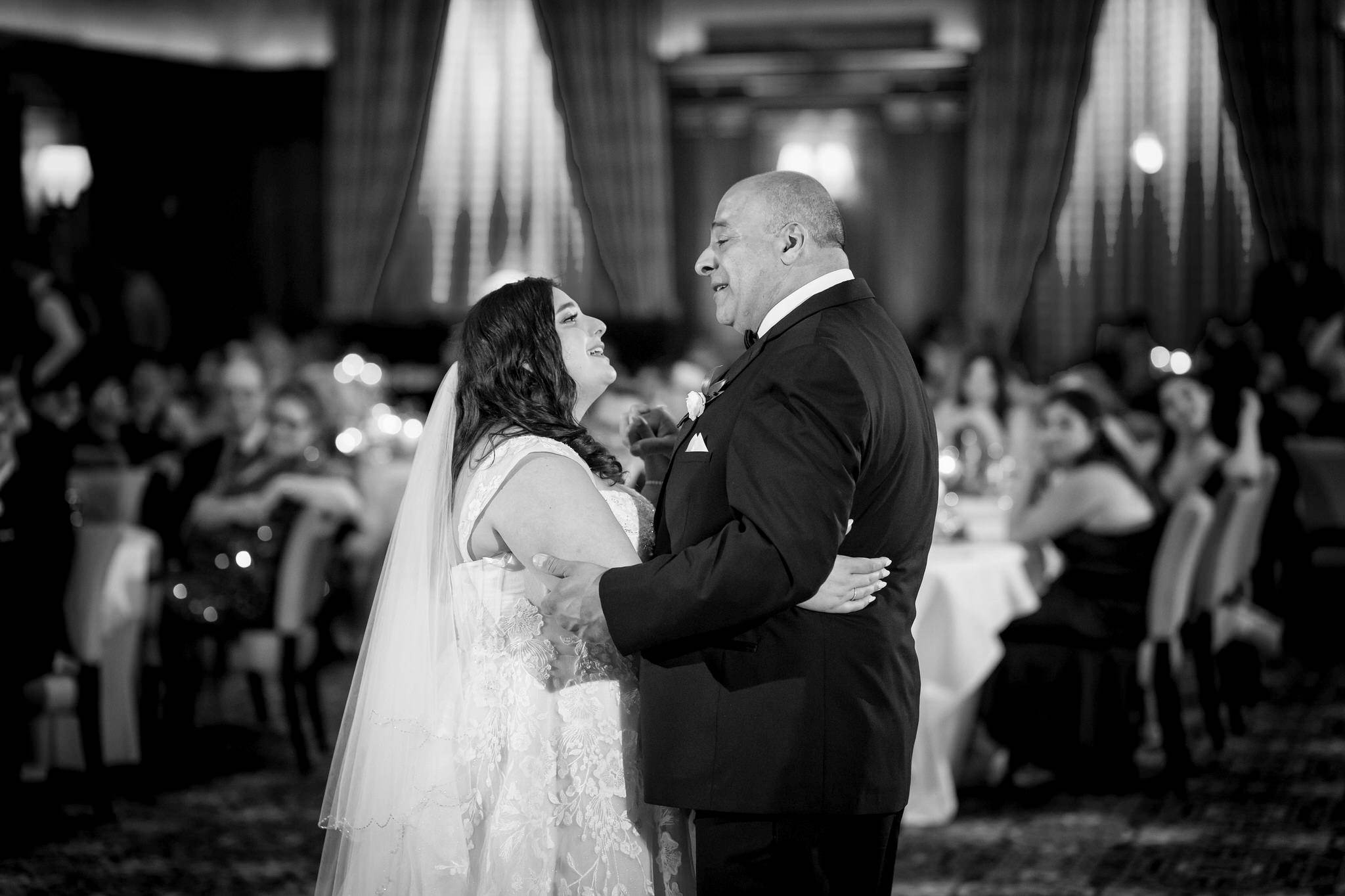 The father of the bride sings to his daughter during their slow dance at a Detroit Athletic Club wedding.