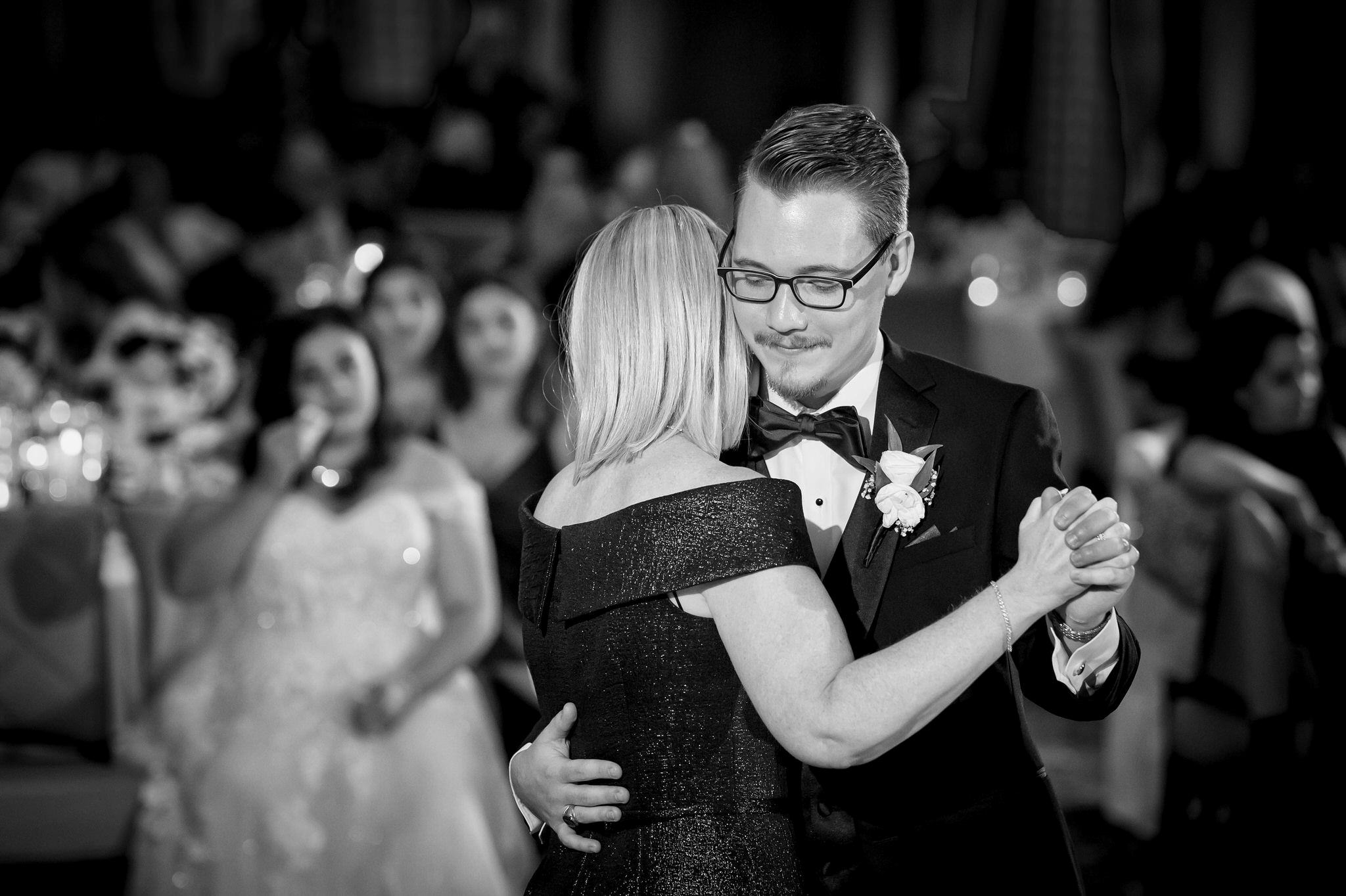 The groom dances with his mom at a Detroit Athletic Club wedding.