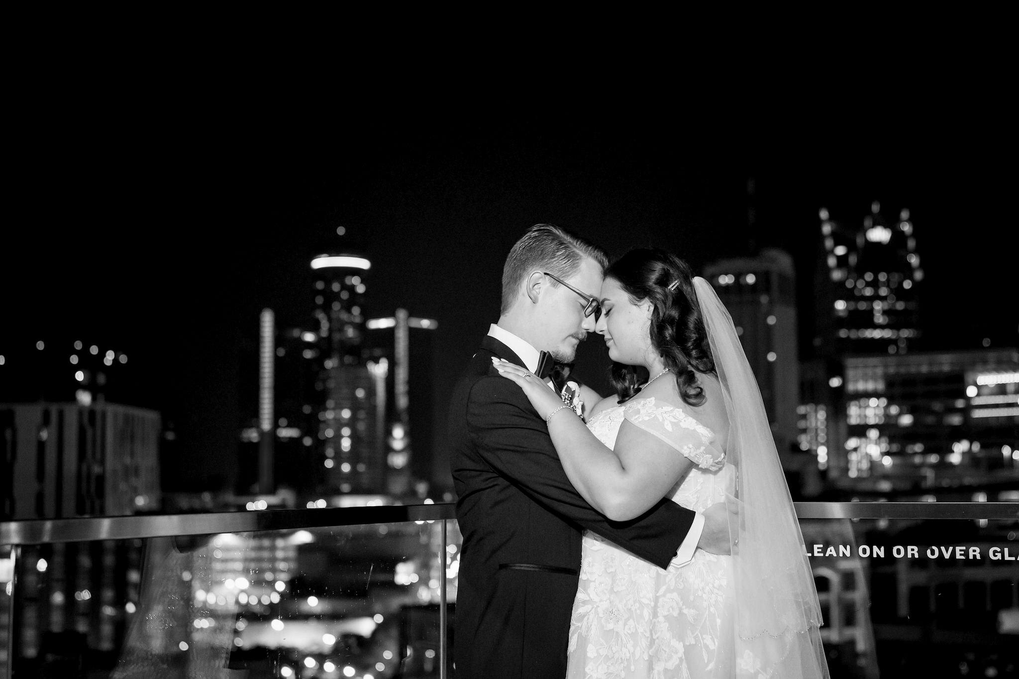 A rooftop photo of a couple celebrating their Detroit Athletic Club wedding.