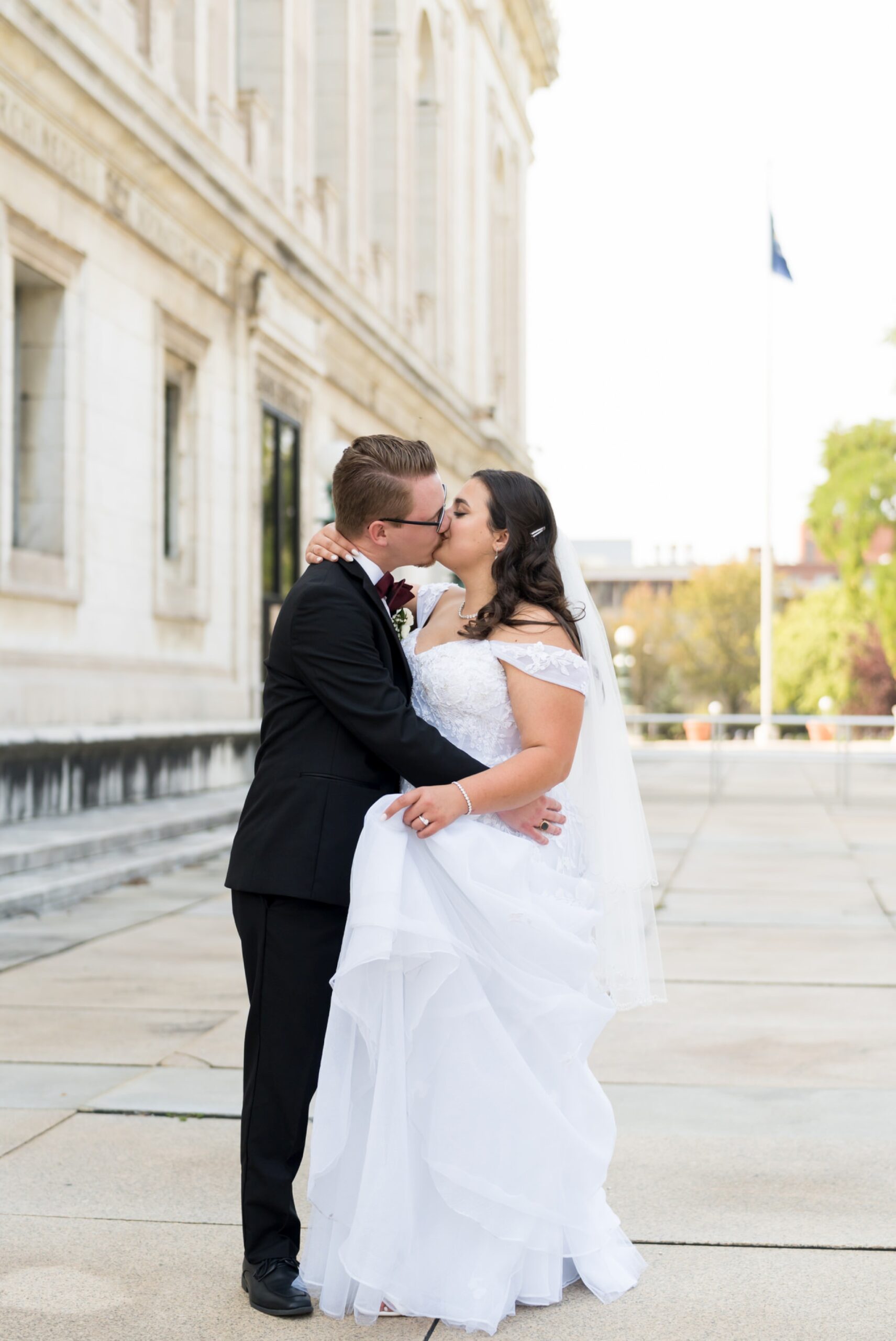 A bride and groom kiss on their wedding day outside the Detroit Public Library.  