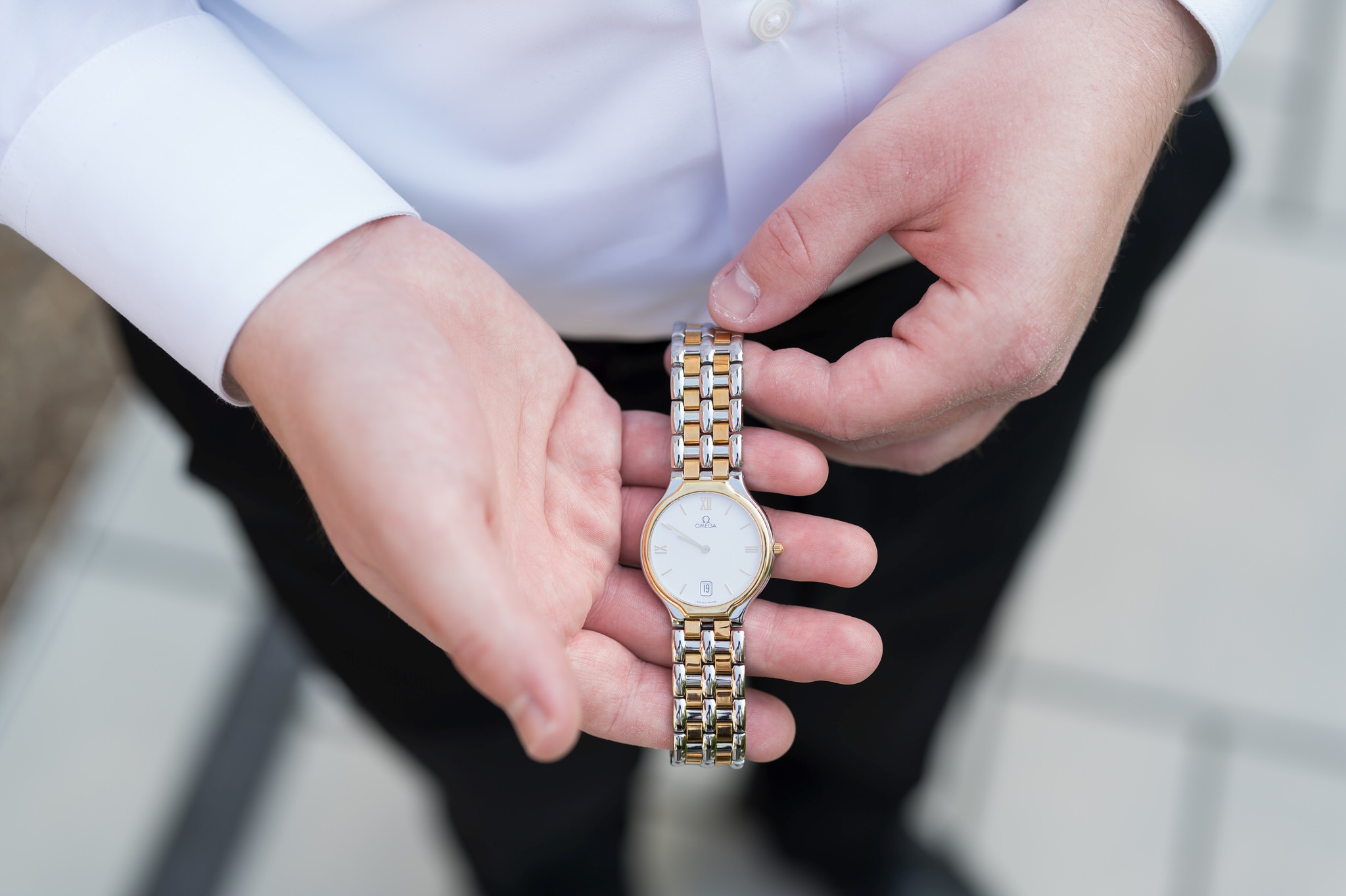 A groom shows an Omega watch.
