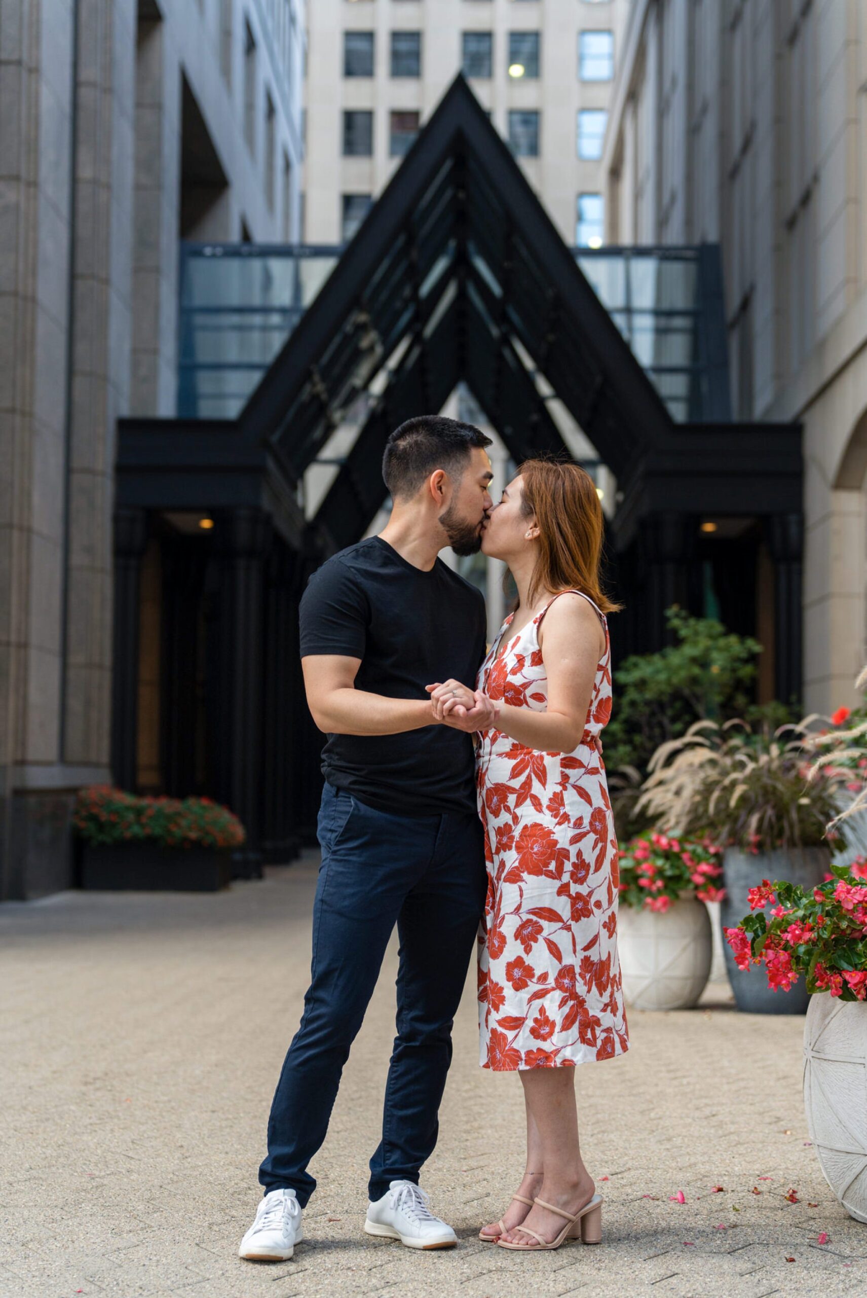 A couple kisses outside of a Townhouse proposal in Detroit, MI.  