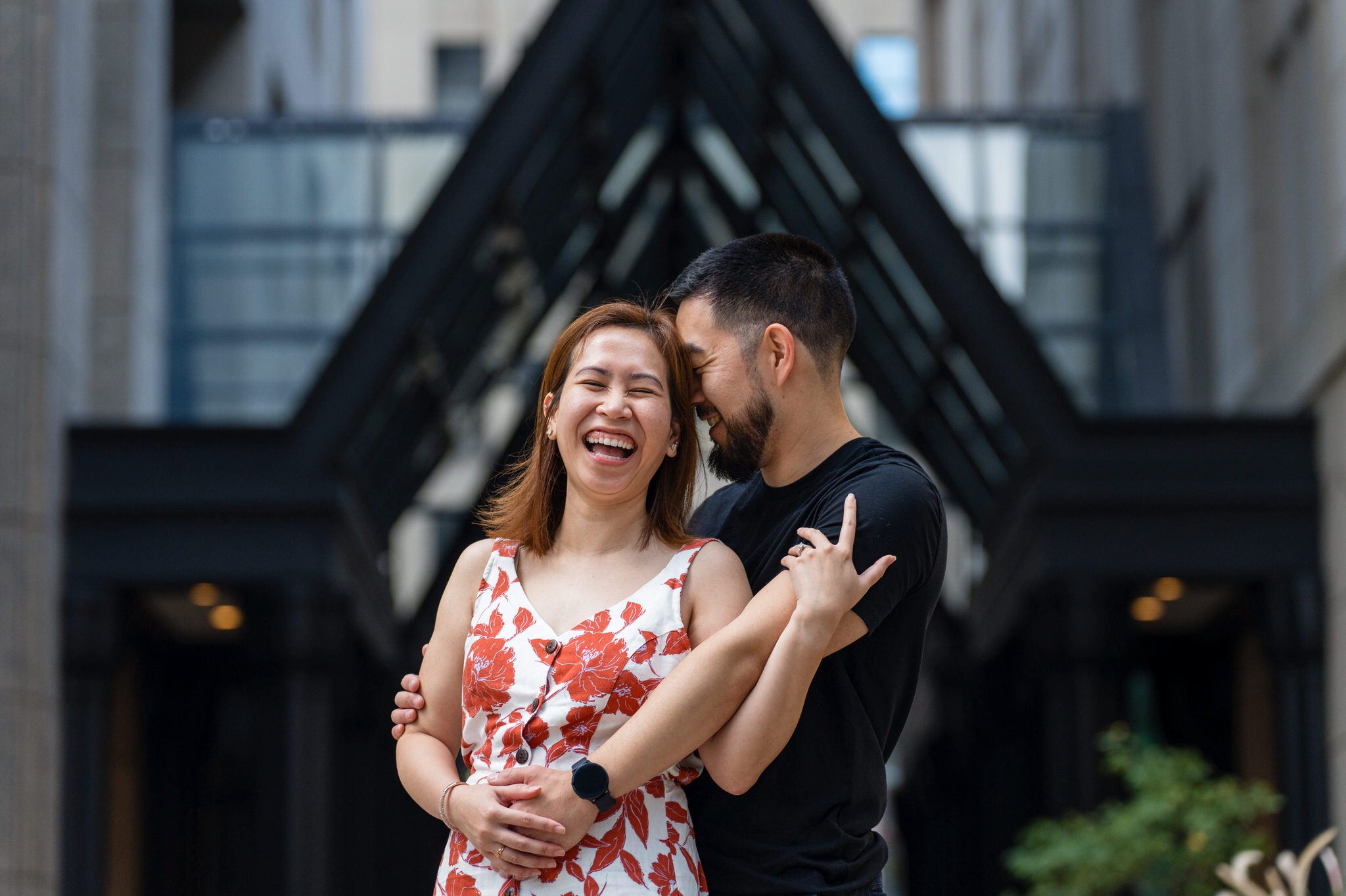 A couple, embracing and laughing, after their Townhouse proposal in Detroit, Michigan.  