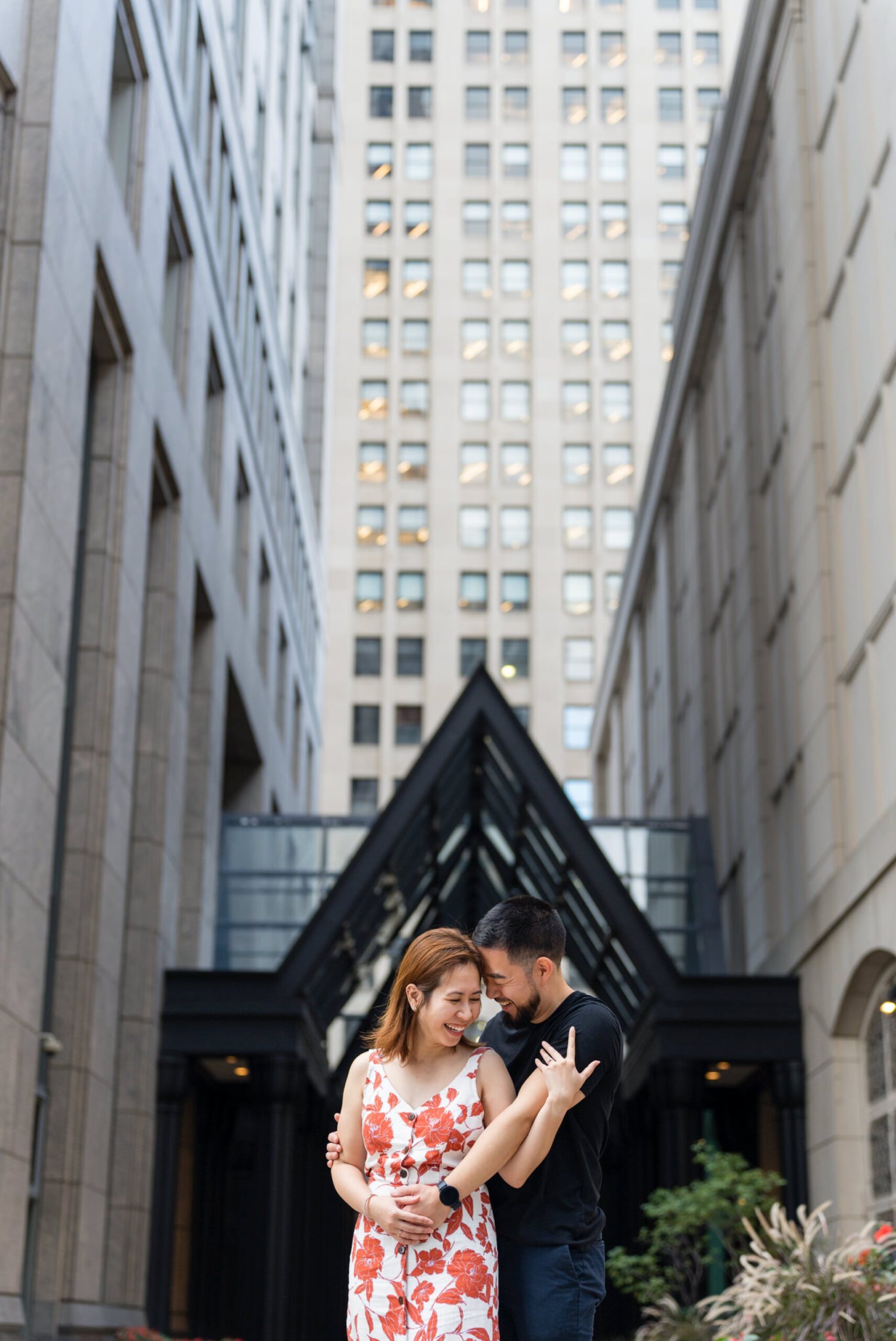 A couple, embracing and laughing, after their Townhouse proposal in Detroit, Michigan.  