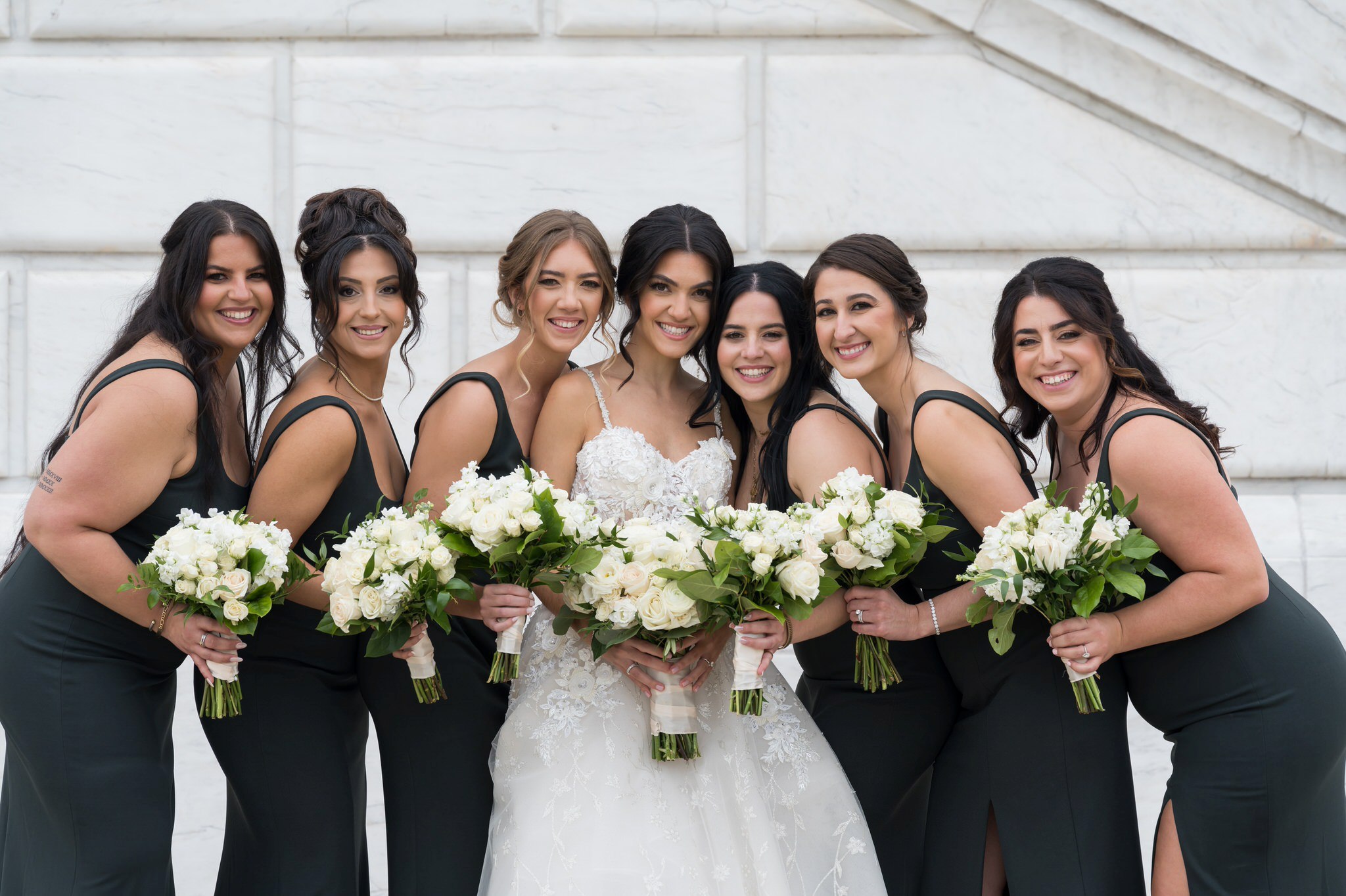 Bridesmaids wearing emerald green dresses cozy up and smile by Brian Weitzel Photography.  