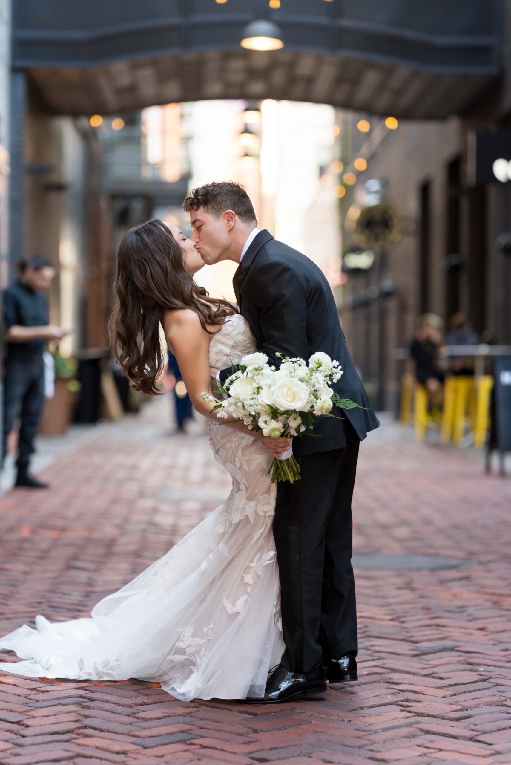 A bride and groom kiss on their wedding day in Parker's Alley.  