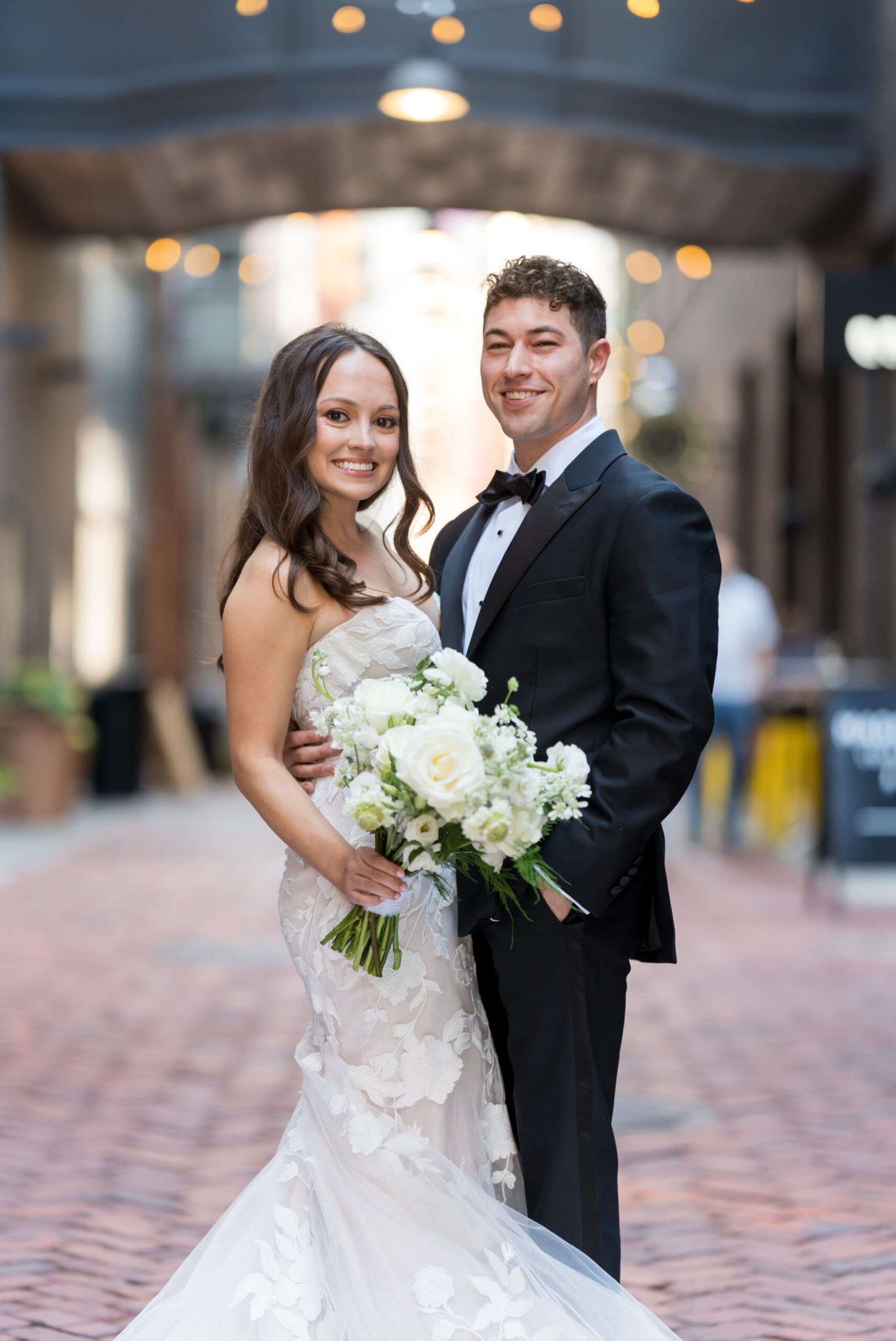 A bride and groom pose on their wedding day in Parker's Alley.  