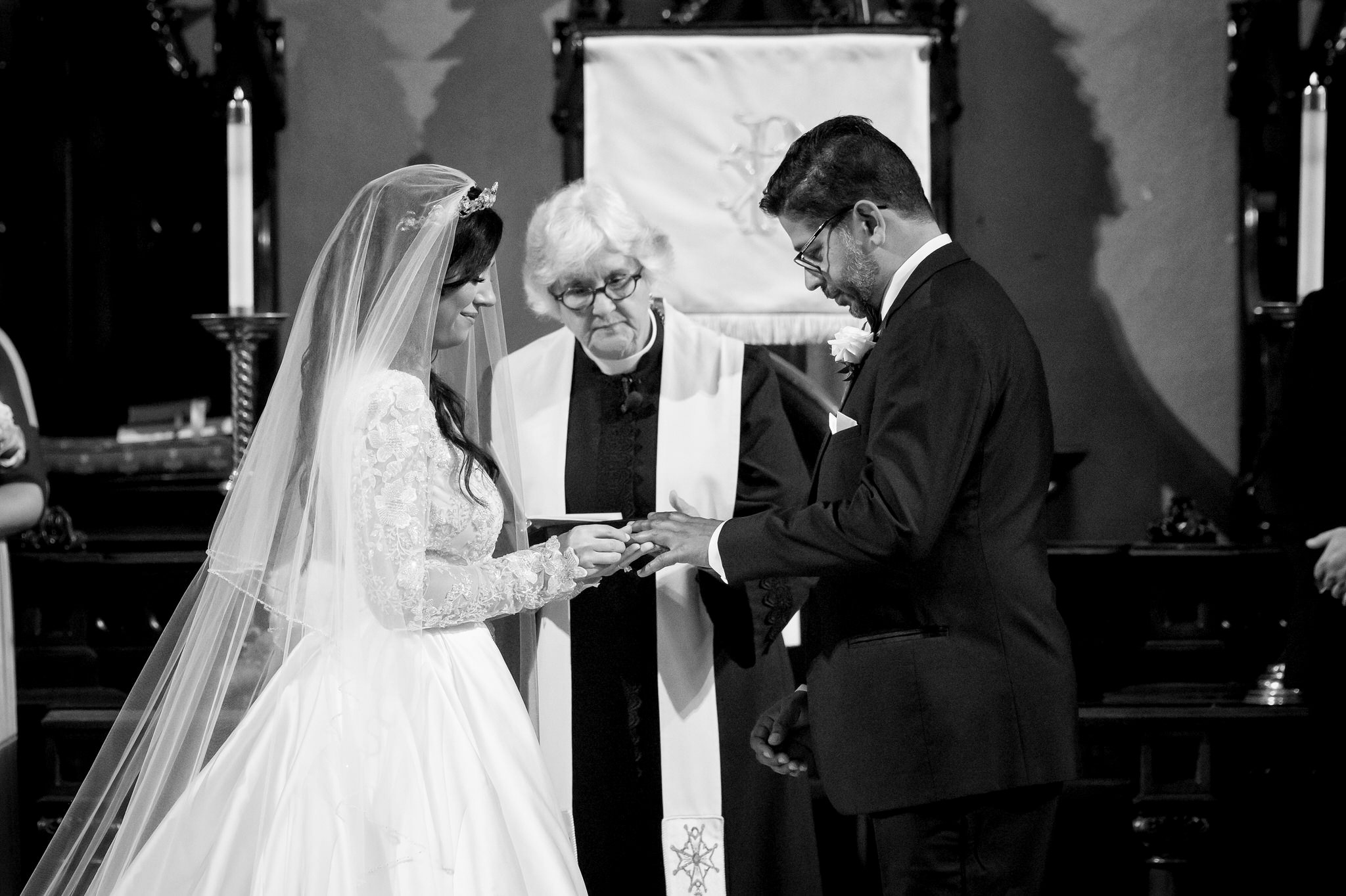 A bride and groom exchange rings at the altar at their Fort Street Presbyterian Church Detroit wedding.