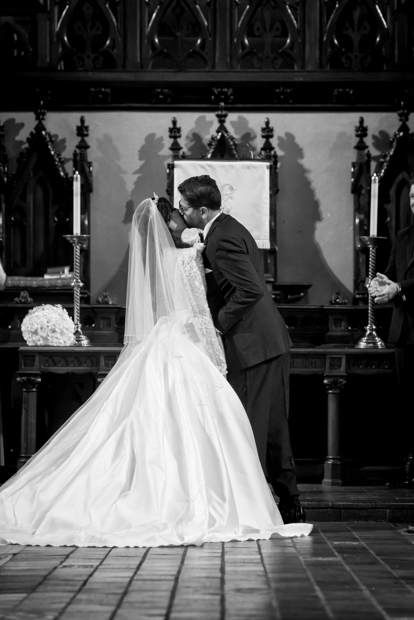 A bride and groom kiss at the altar at their Fort Street Presbyterian Church Detroit wedding.