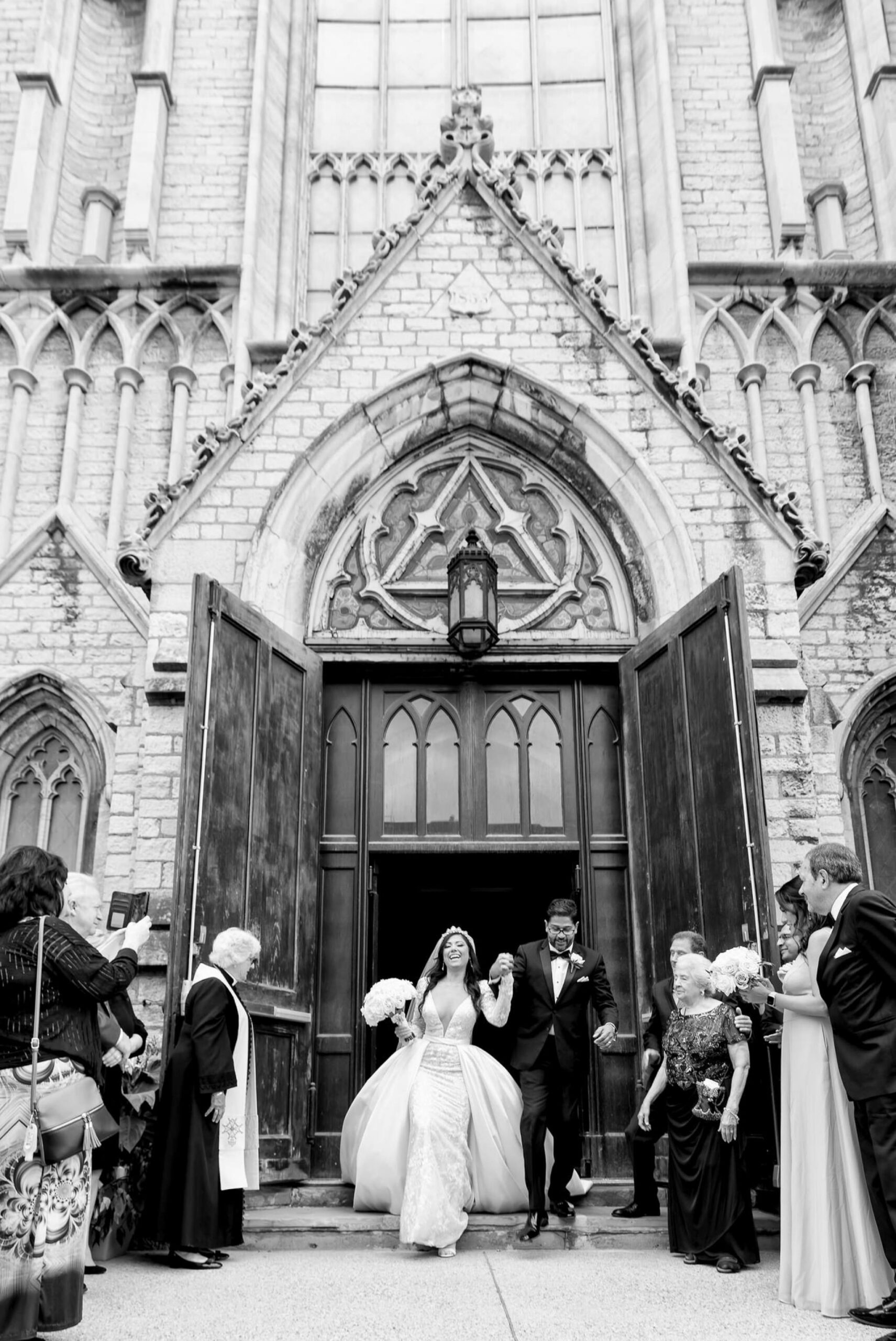 A bride and groom have a grand exit  at their Fort Street Presbyterian Church Detroit wedding