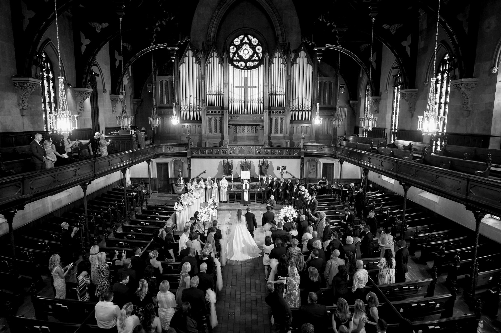A bride walks down the aisle at a Fort Street Presbyterian Church Detroit wedding.