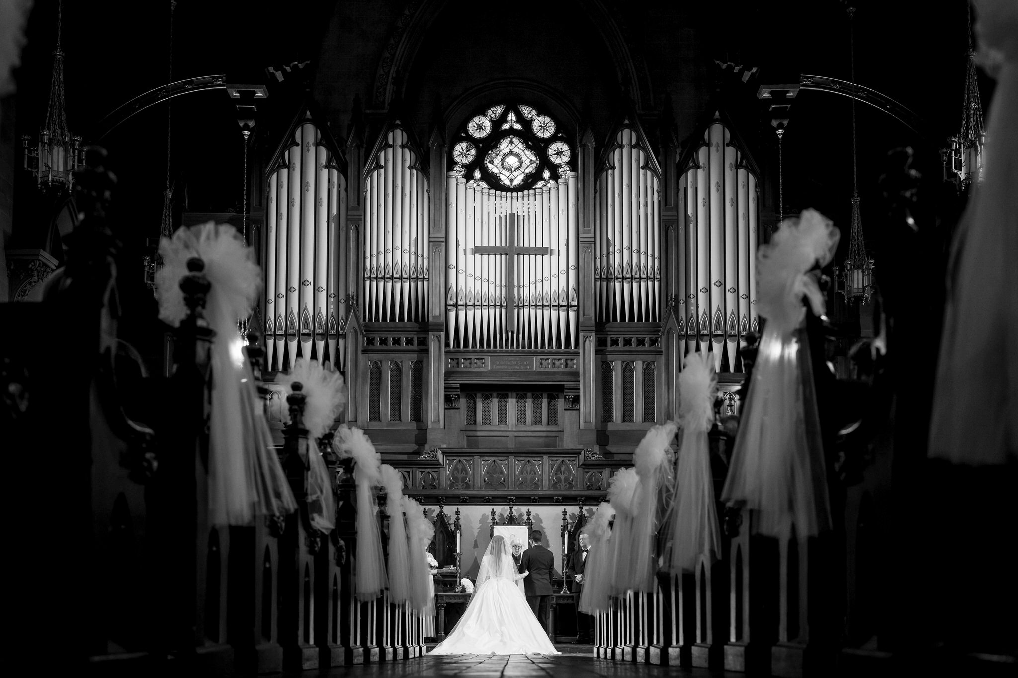 A bride and groom stand near the altar at their Fort Street Presbyterian Church Detroit wedding.