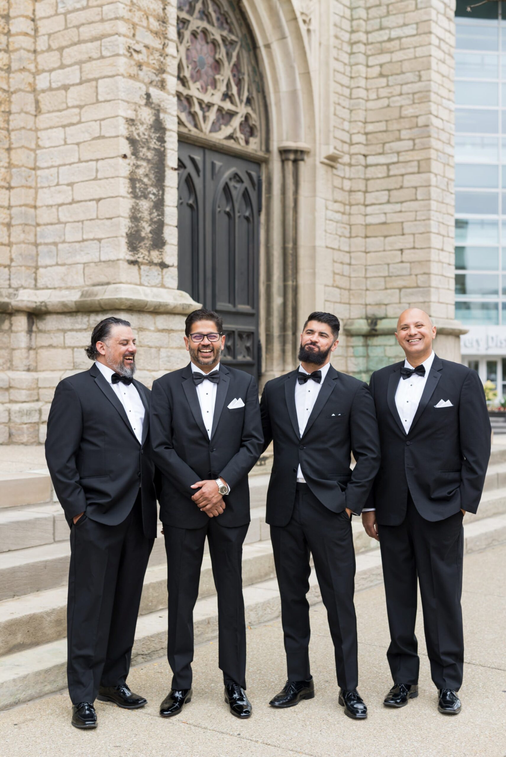 The groom and his groomsmen relax outside of a Fort Street Presbyterian Detroit wedding. 
