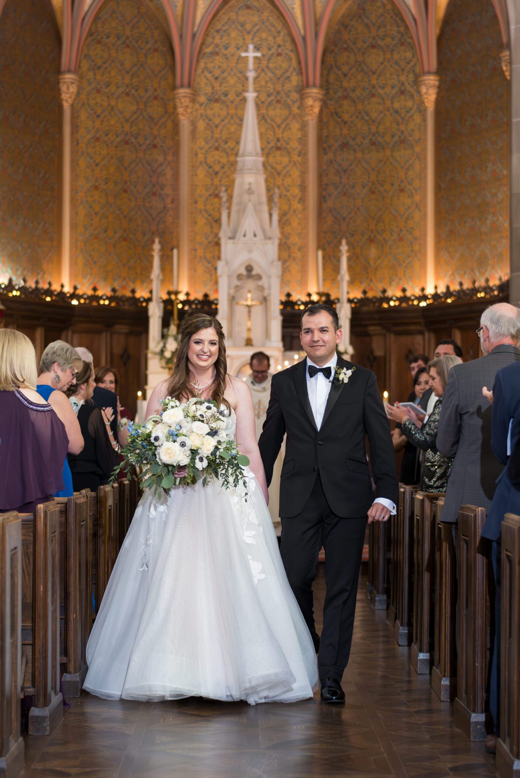 A bride and groom walk down the aisle at their Grosse Pointe Academy wedding.  