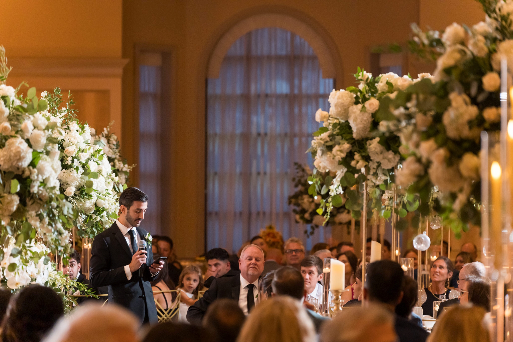 A groomsman offers a wedding toast at a Palazzo Grande reception.  