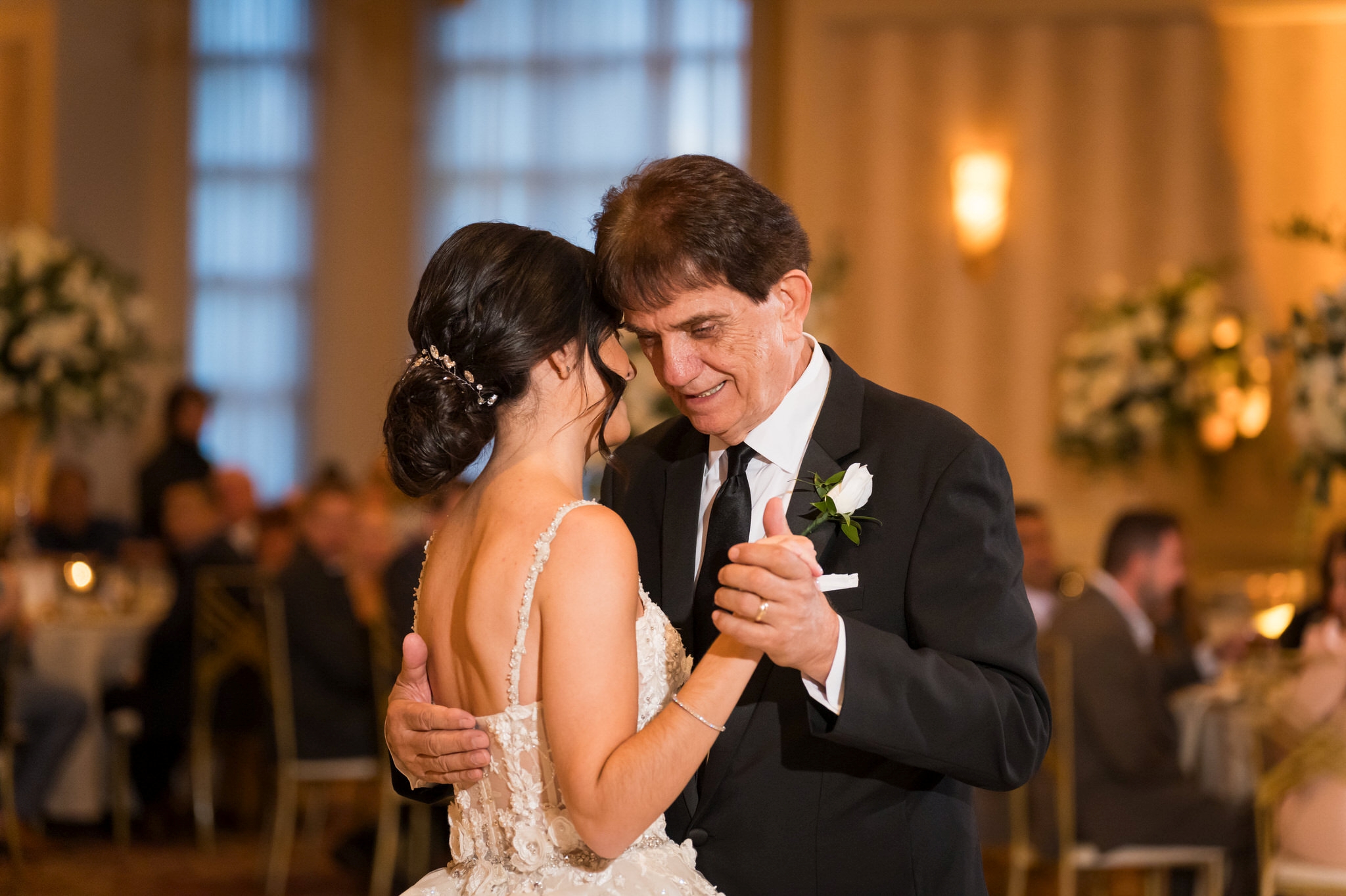 A bride dances with her dad during her wedding reception at Palazzo Grande.  