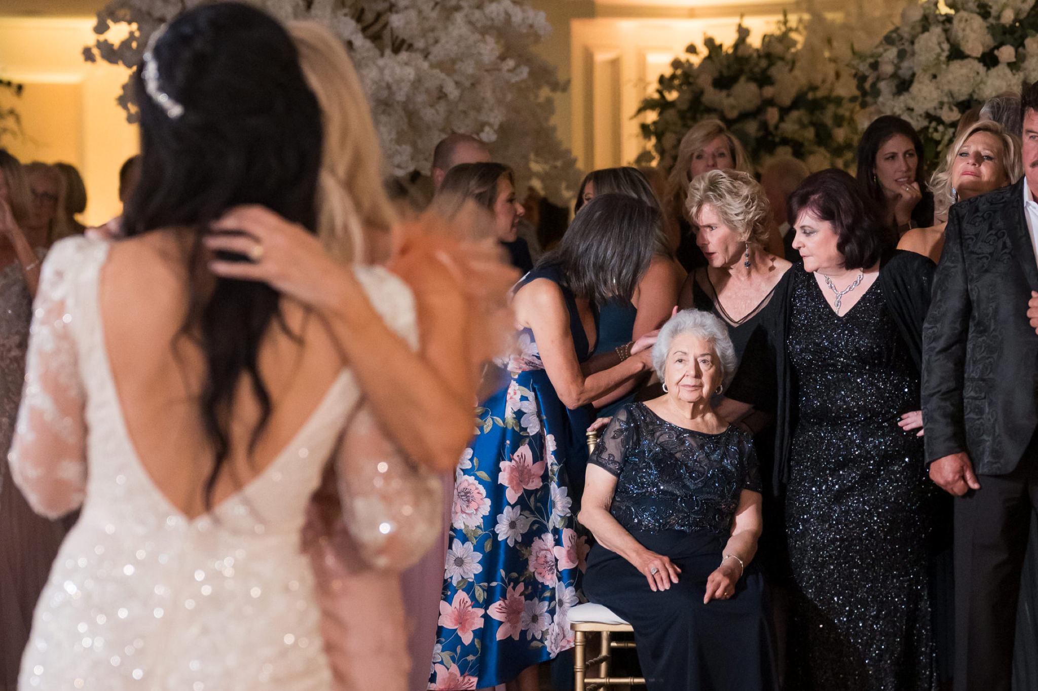 A grandma watches as he daughter and granddaughter share a first dance at a wedding reception at Penna's of Sterling. 