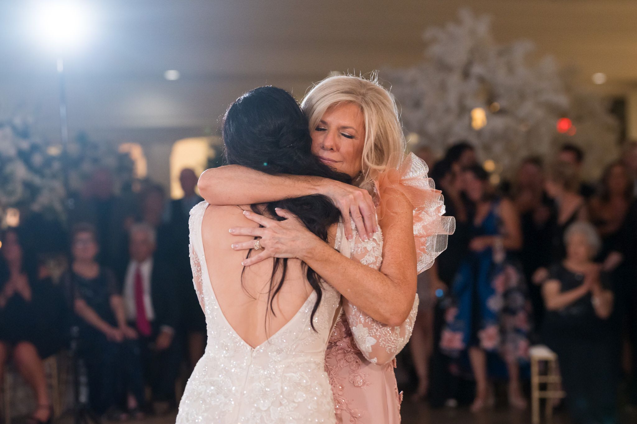 A mother and daughter hug after sharing a first dance at Penna's of Sterling. 