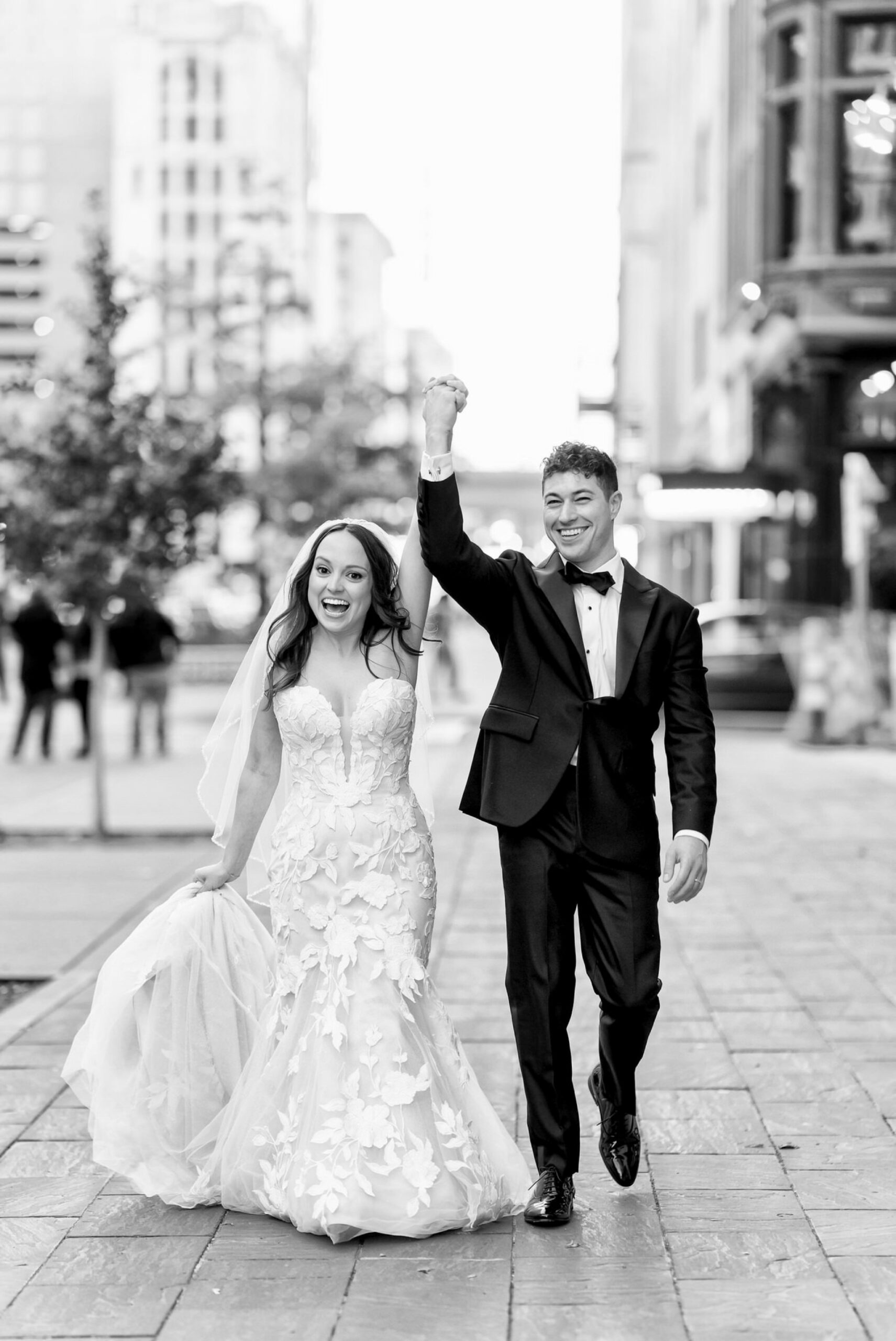 A newlywed couple walks down Woodward Ave after celebrating their San Morello wedding. 