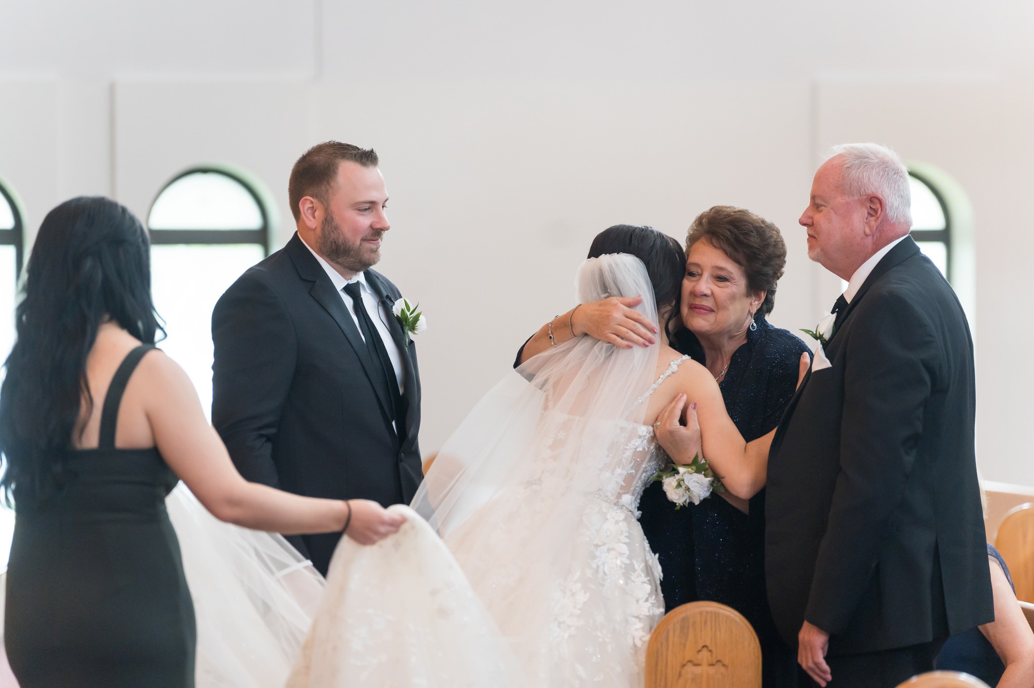A bride hugs her mother-in-law during her Assumption Greek Orthodox wedding in St. Clair Shores, Michigan.