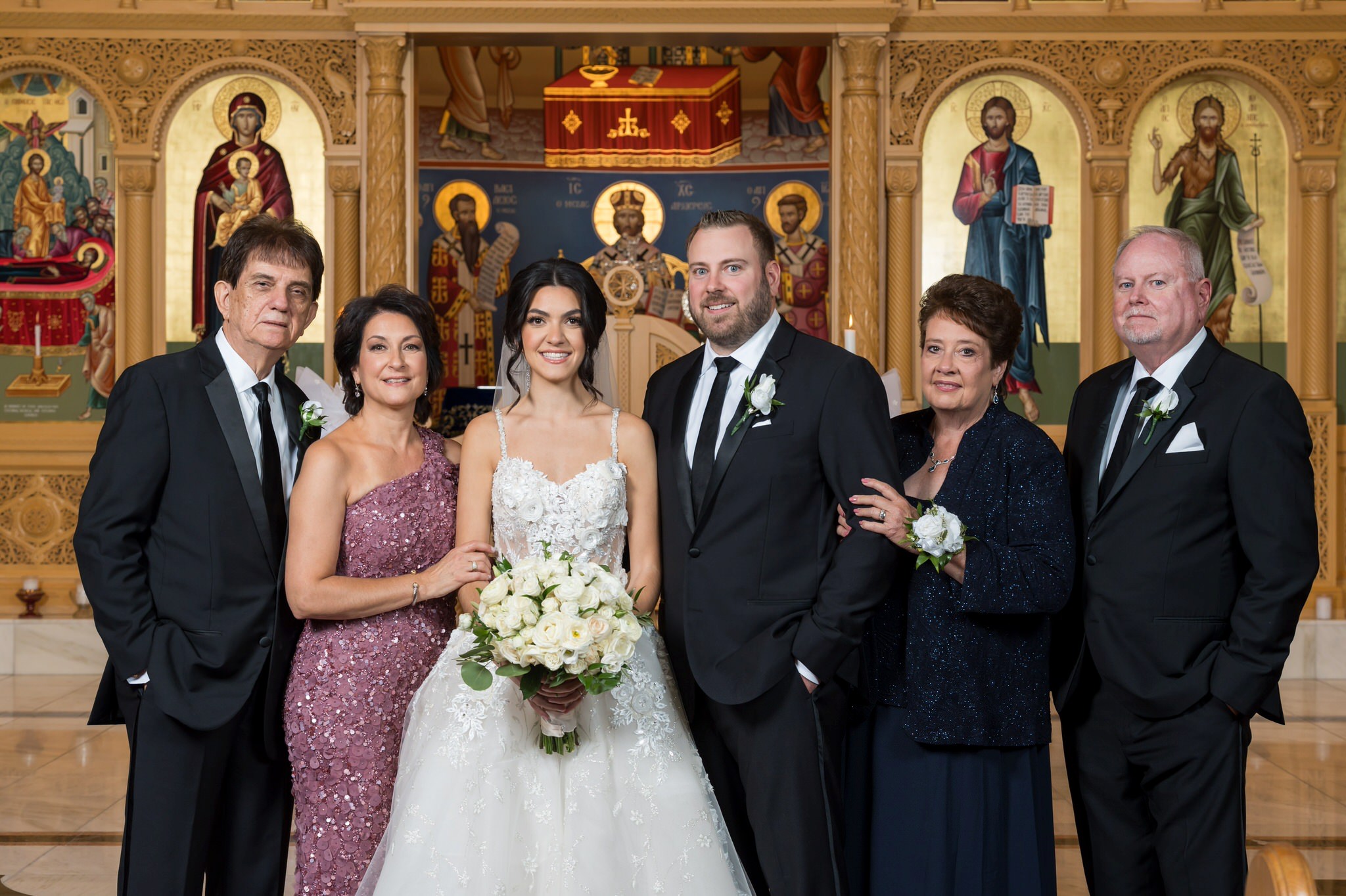 A family formal at the altar of an Assumption Greek Orthodox wedding in St. Claire Shores, Michigan. 