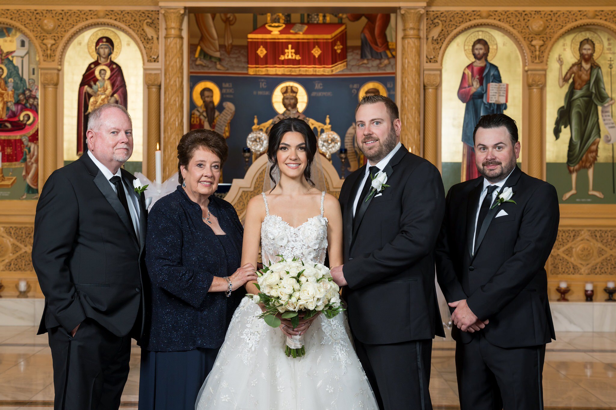 A family formal at the altar of an Assumption Greek Orthodox wedding in St. Clair Shores, Michigan. 