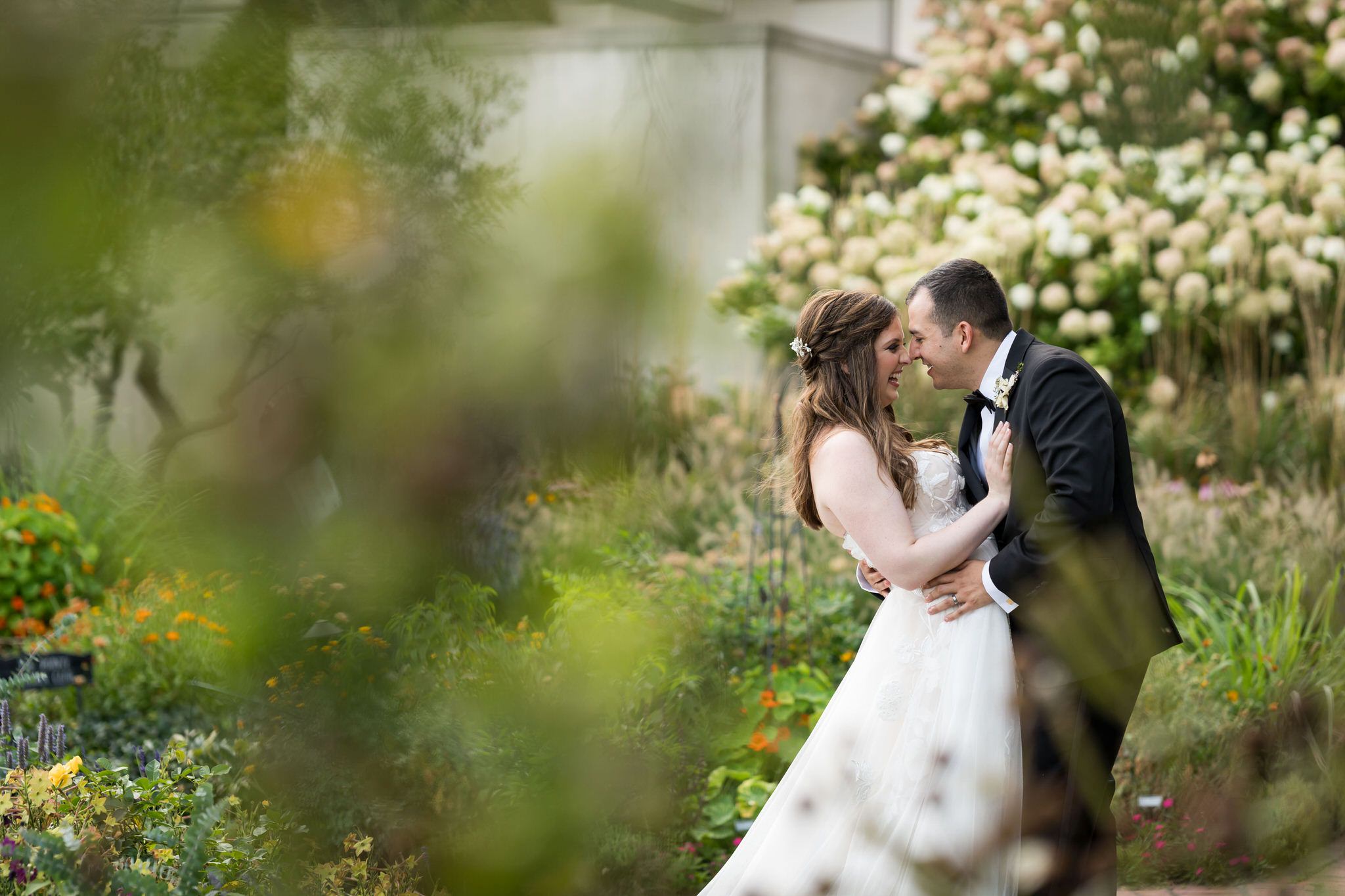 The bride and groom  are photographed in the gardens during their wedding at The War Memorial.  