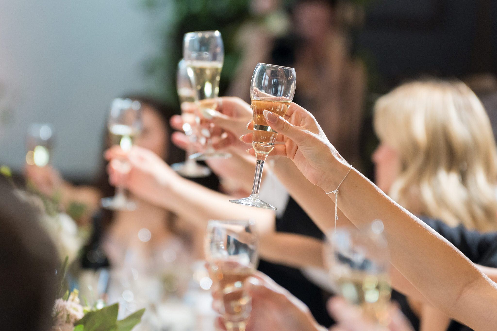 Guests raise champagne glasses during wedding toasts at Walnut Creek Golf Club in South Lyon, MI.  