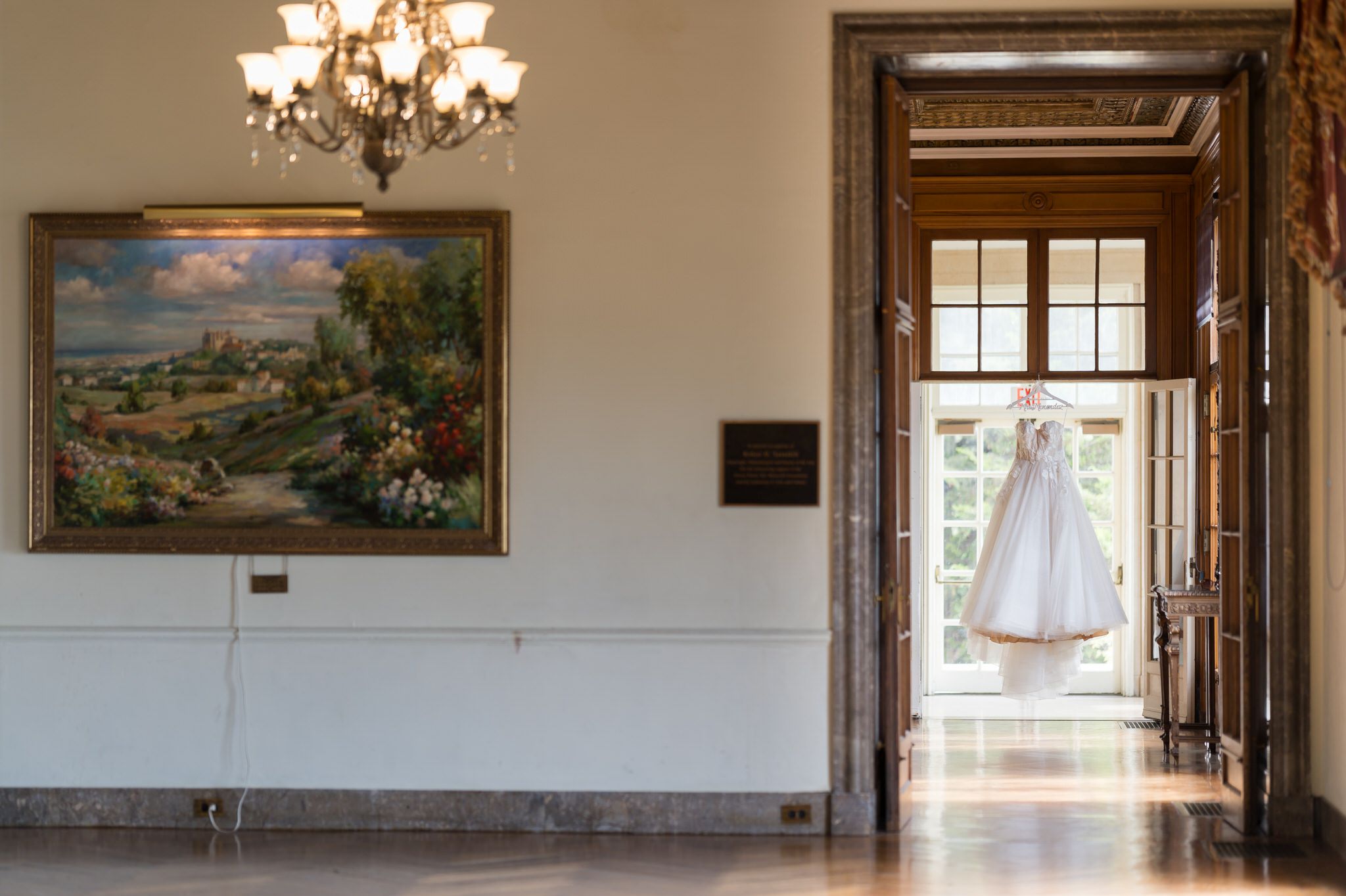 A wedding dress hangs in the doorway of the War Memorial.  