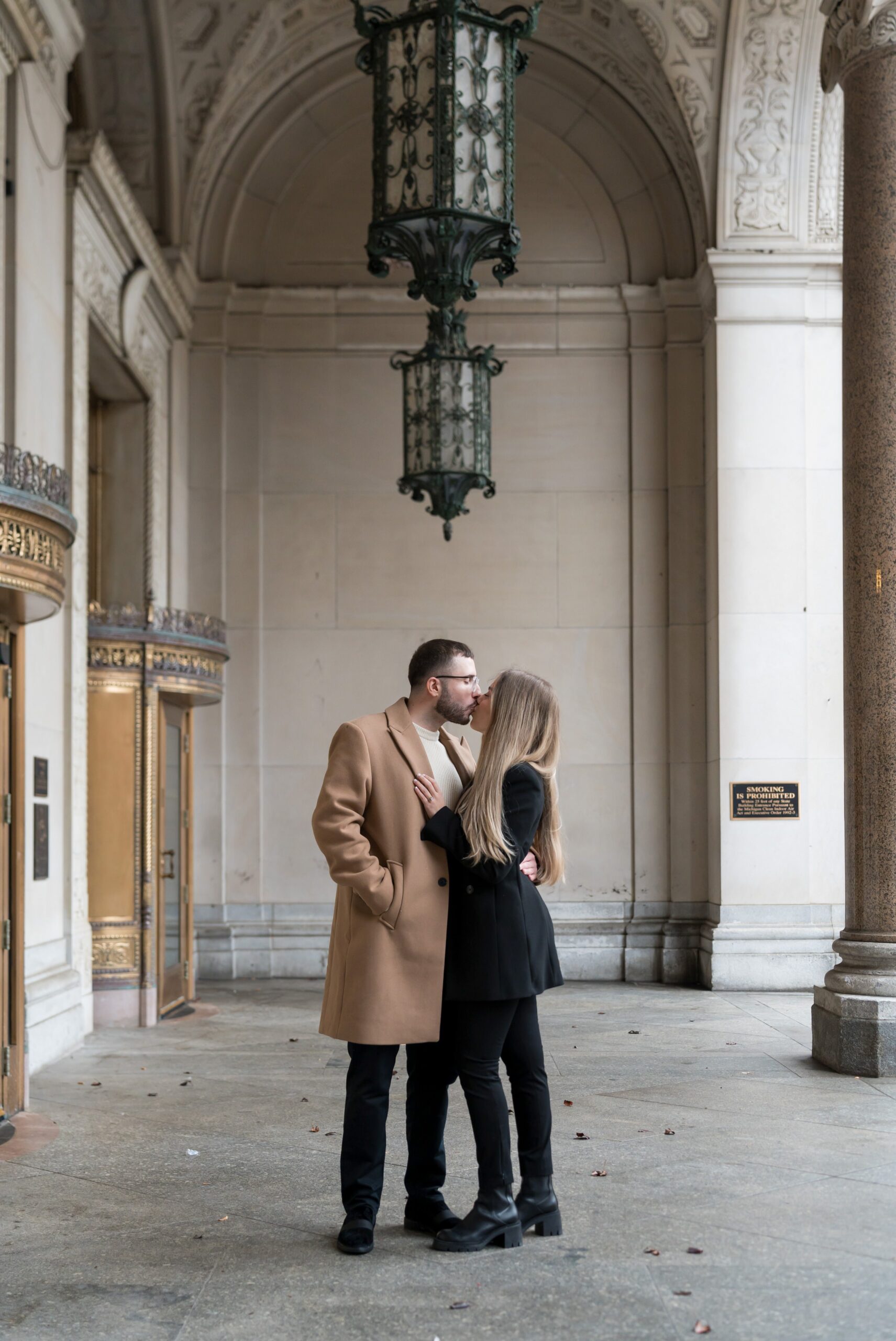 A couple kisses after their Cadillac Place proposal in Detroit. 